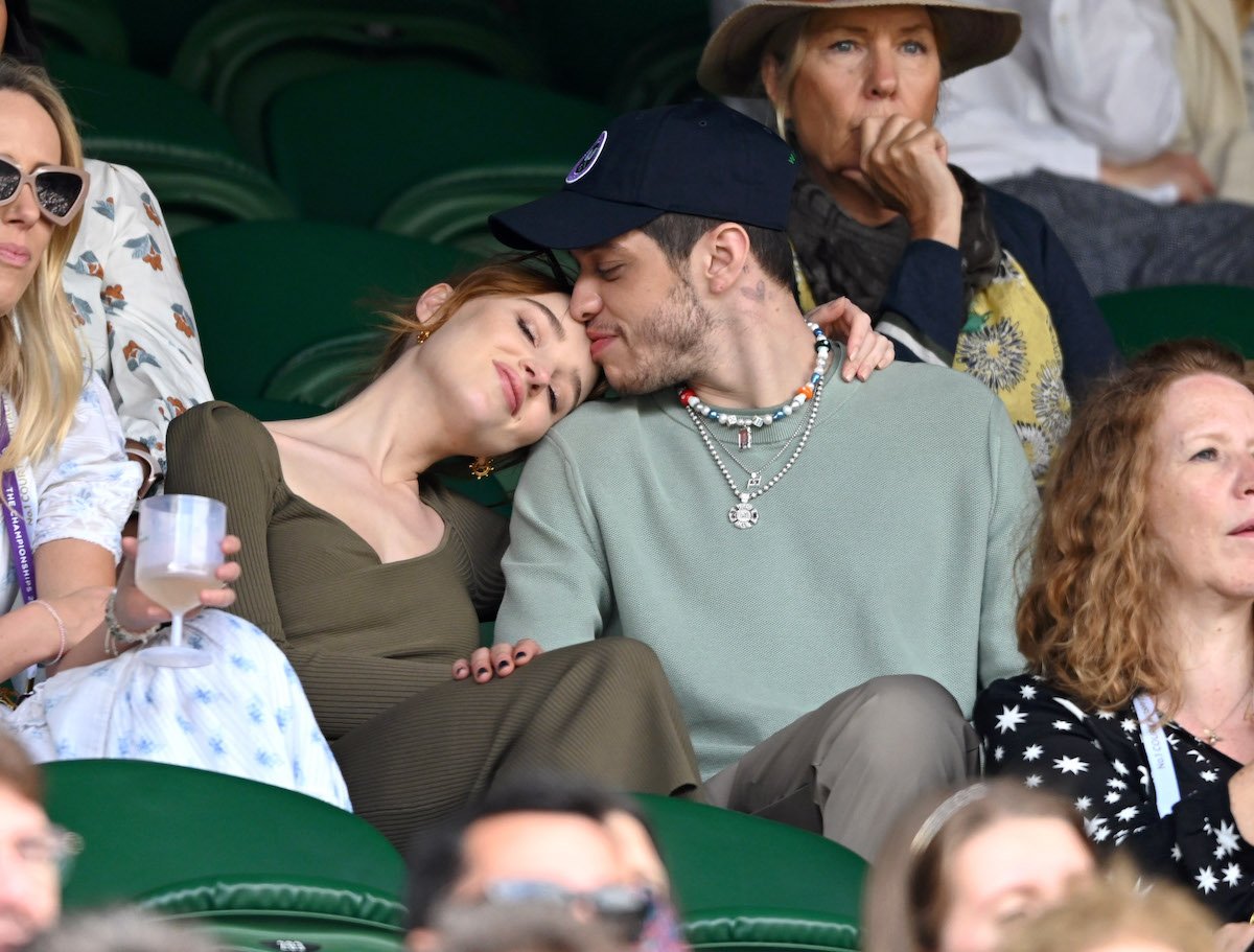 Pete Davidson kisses Phoebe Dynevor's forehead as they watch a match at Wimbledon.