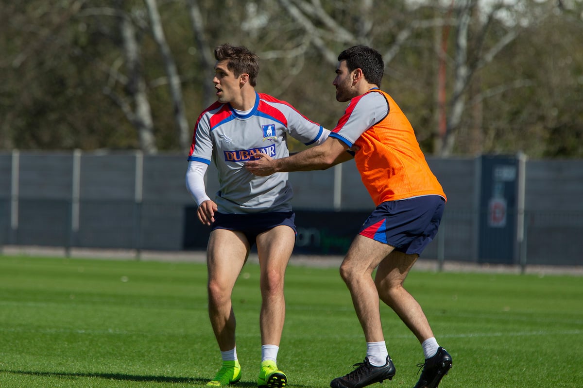 Phil Dunster as Jamie Tartt and Brett Goldstein as Roy Kent guard each other on the pitch during a scene on 'Ted Lasso'