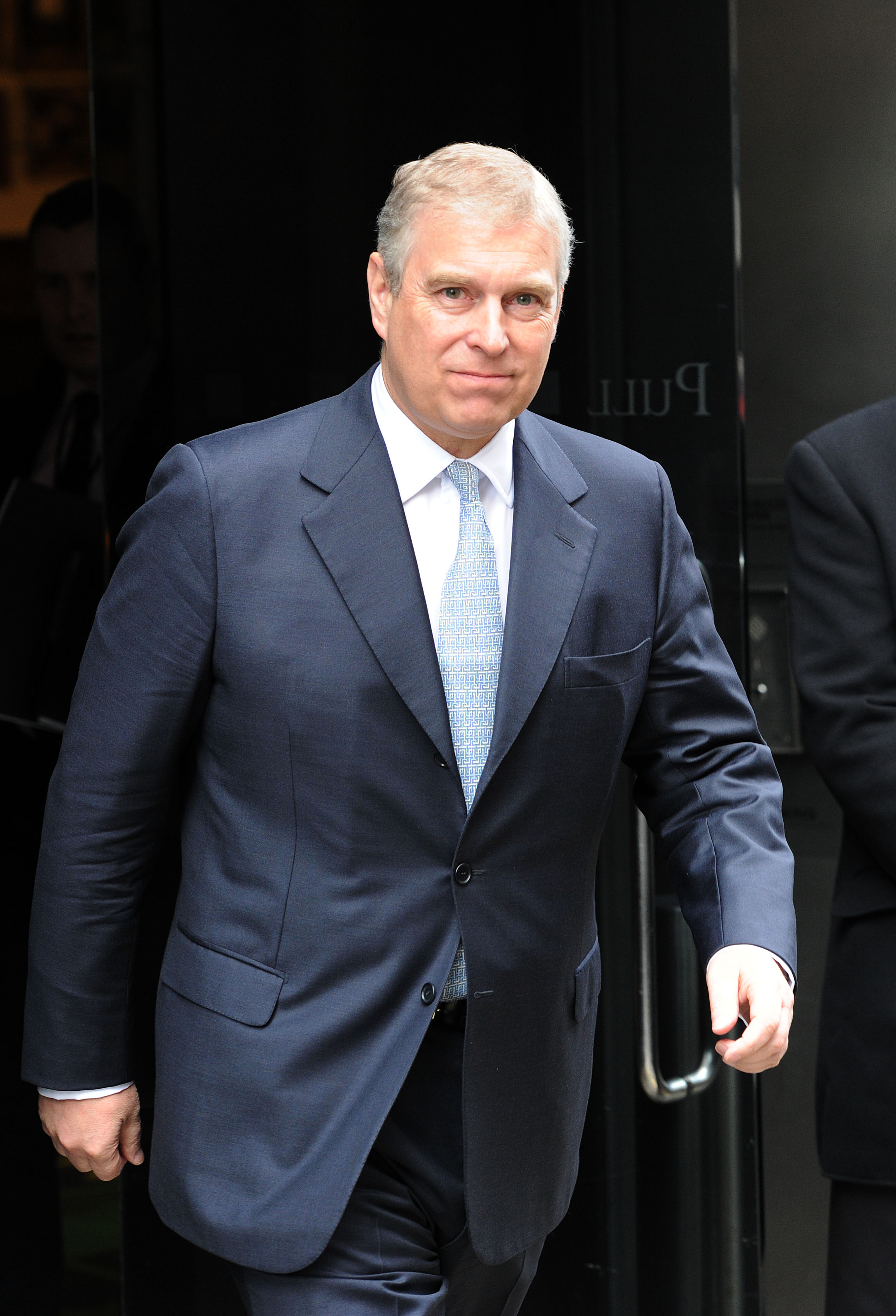 Prince Andrew slightly smiling after visiting Mother London