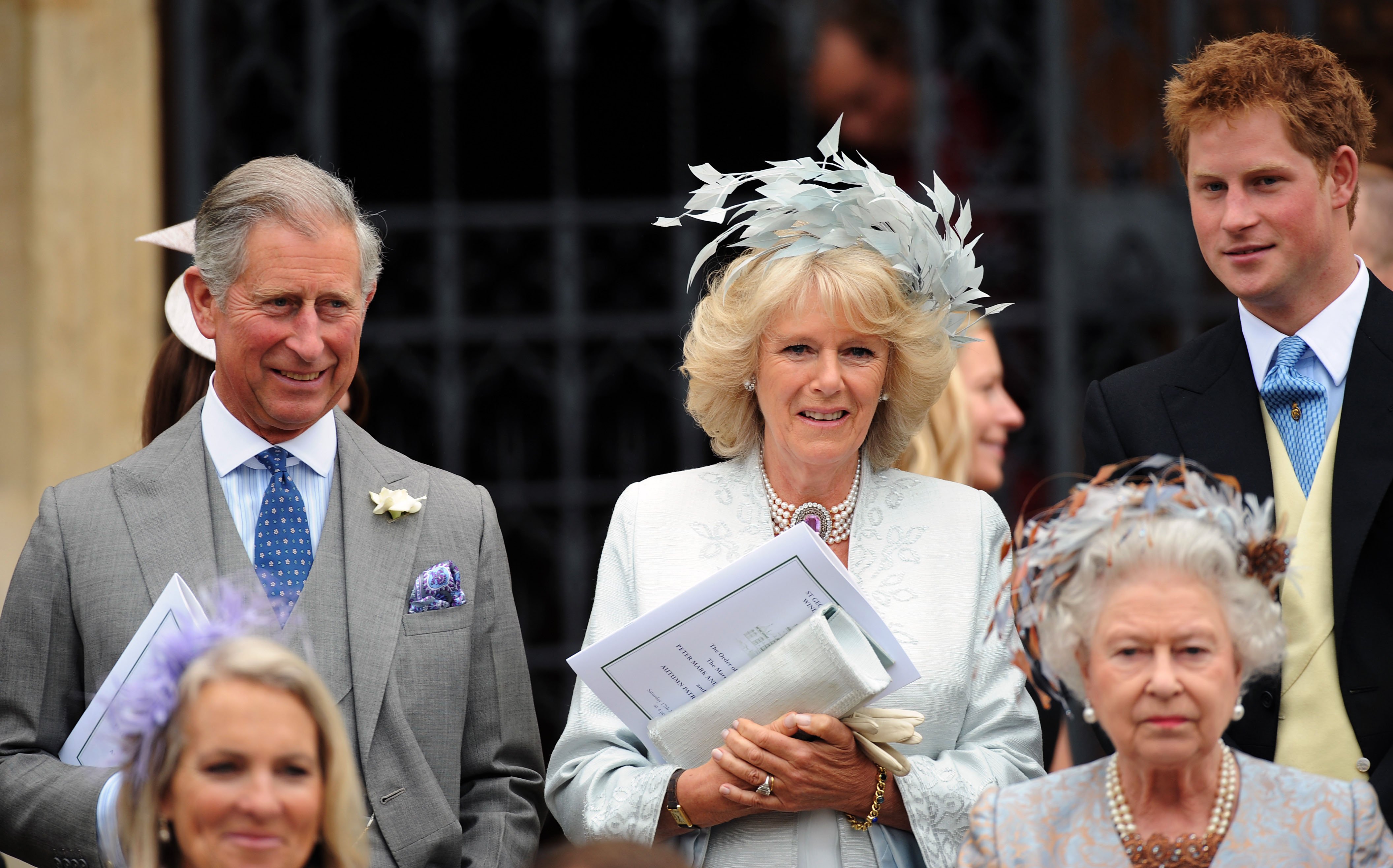 Prince Charles, Camilla Parker Bowles, Prince Harry, and Queen Elizabeth II attending Peter Phillips and Autumn Kelly's wedding