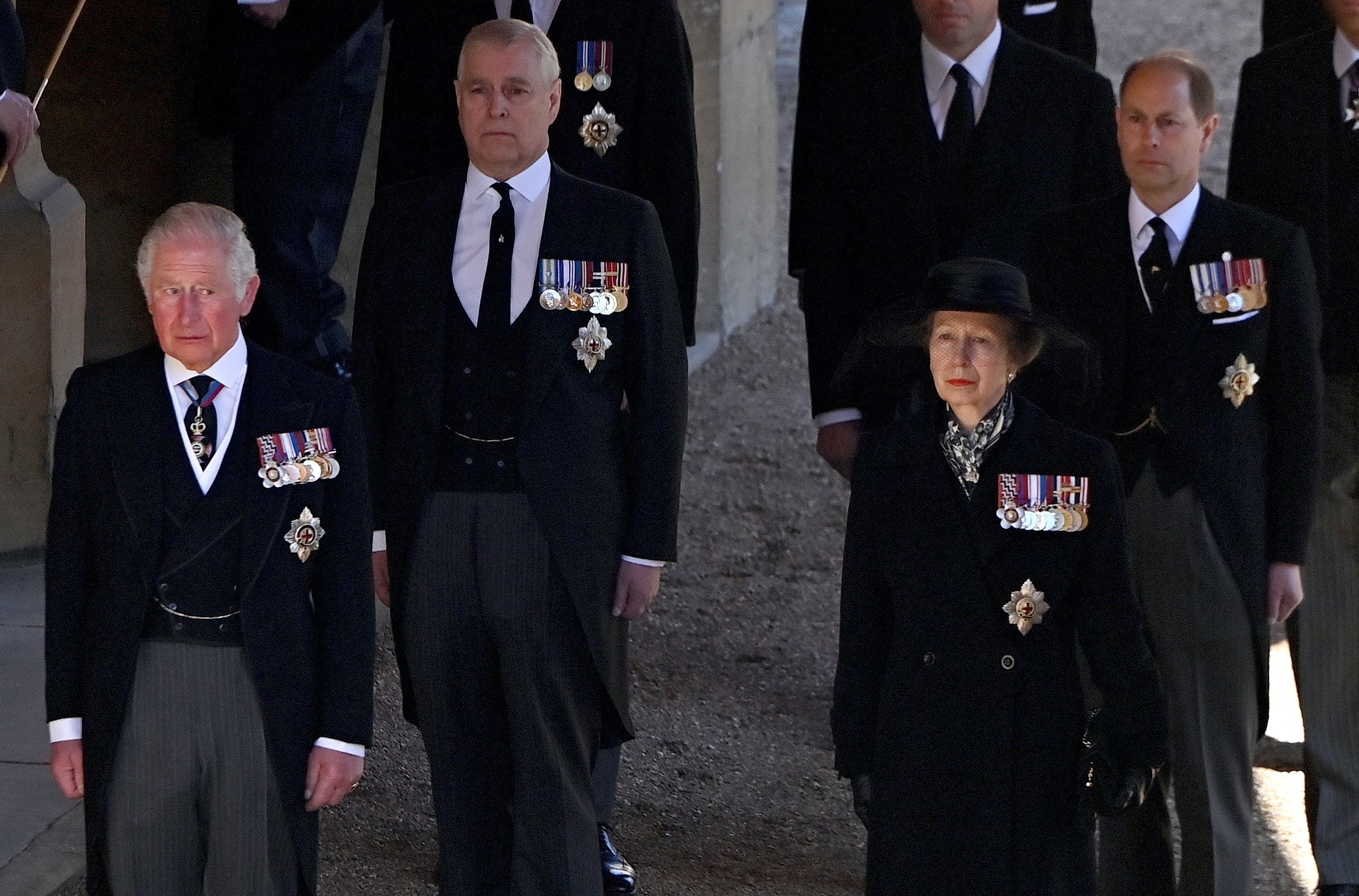 Prince Charles, Princess Anne, Prince Andrew, and Prince Edward follow Prince Philip's coffin