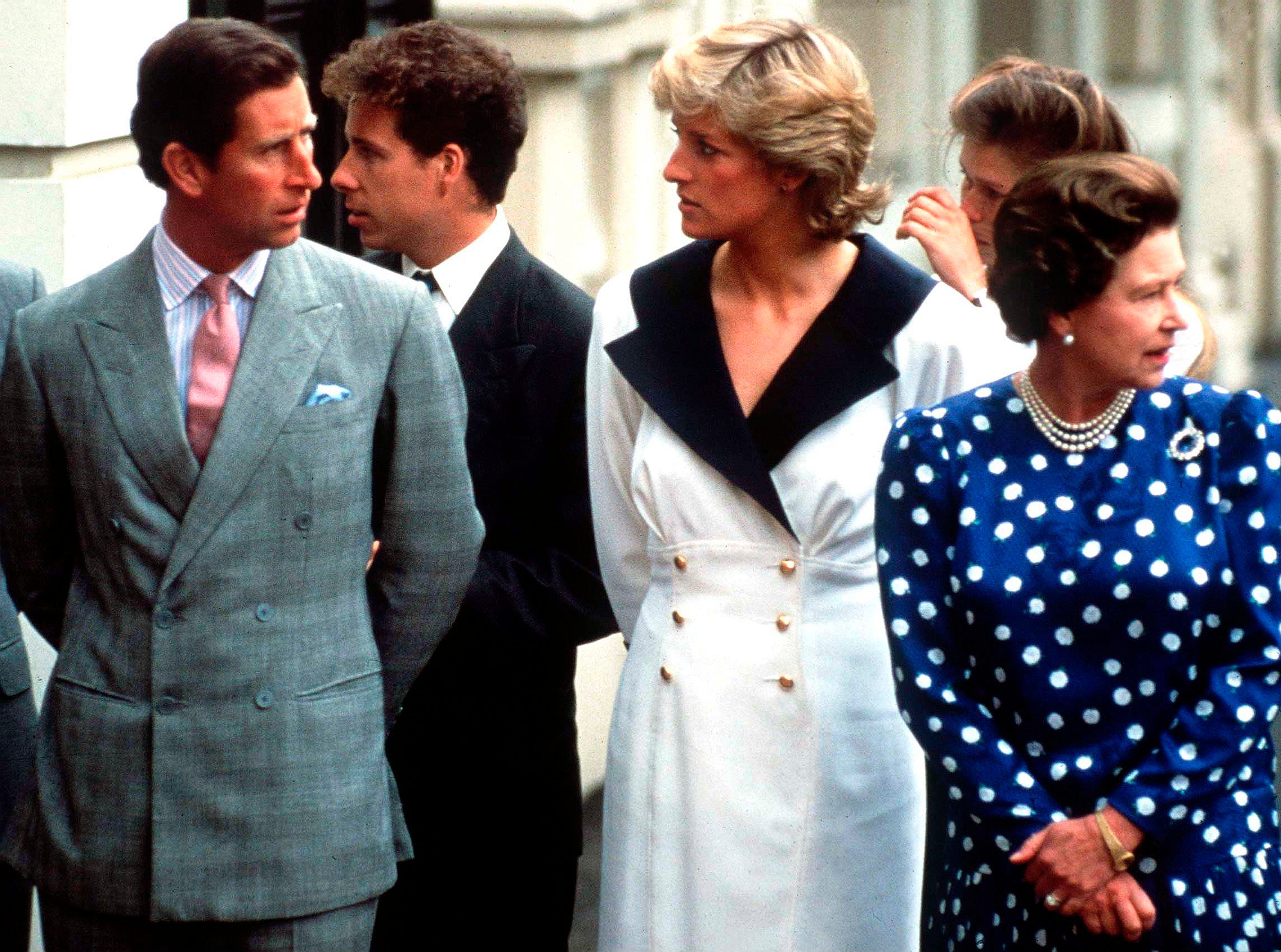 Prince Charles and Princess Diana glaring at each other next to Queen Elizabeth II outside Clarence House