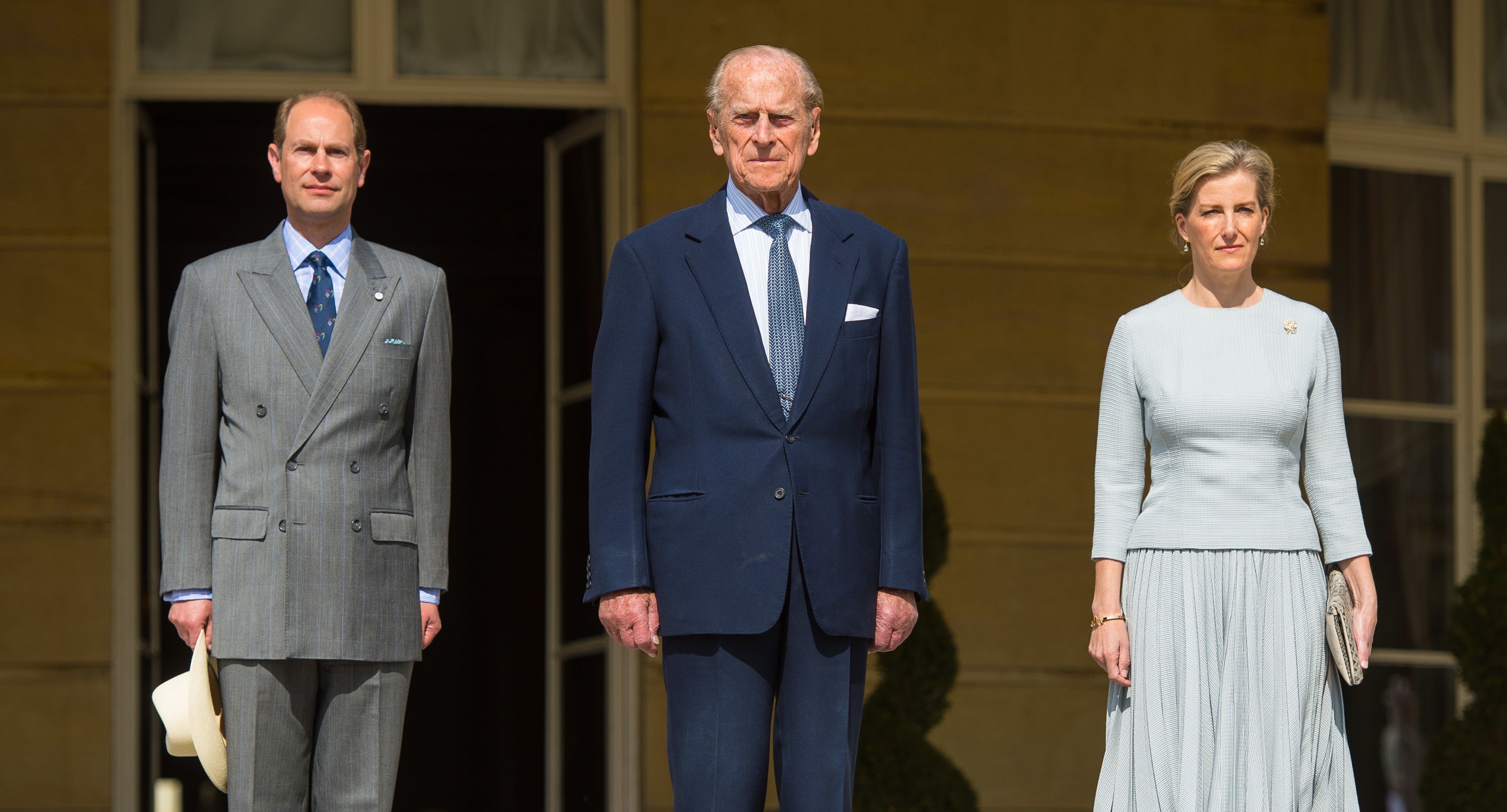 Prince Edward, Prince Philip, and Sophie, Countess of Wessex standing next to one another at the Duke of Edinburgh Award's 60th Anniversary Garden Party