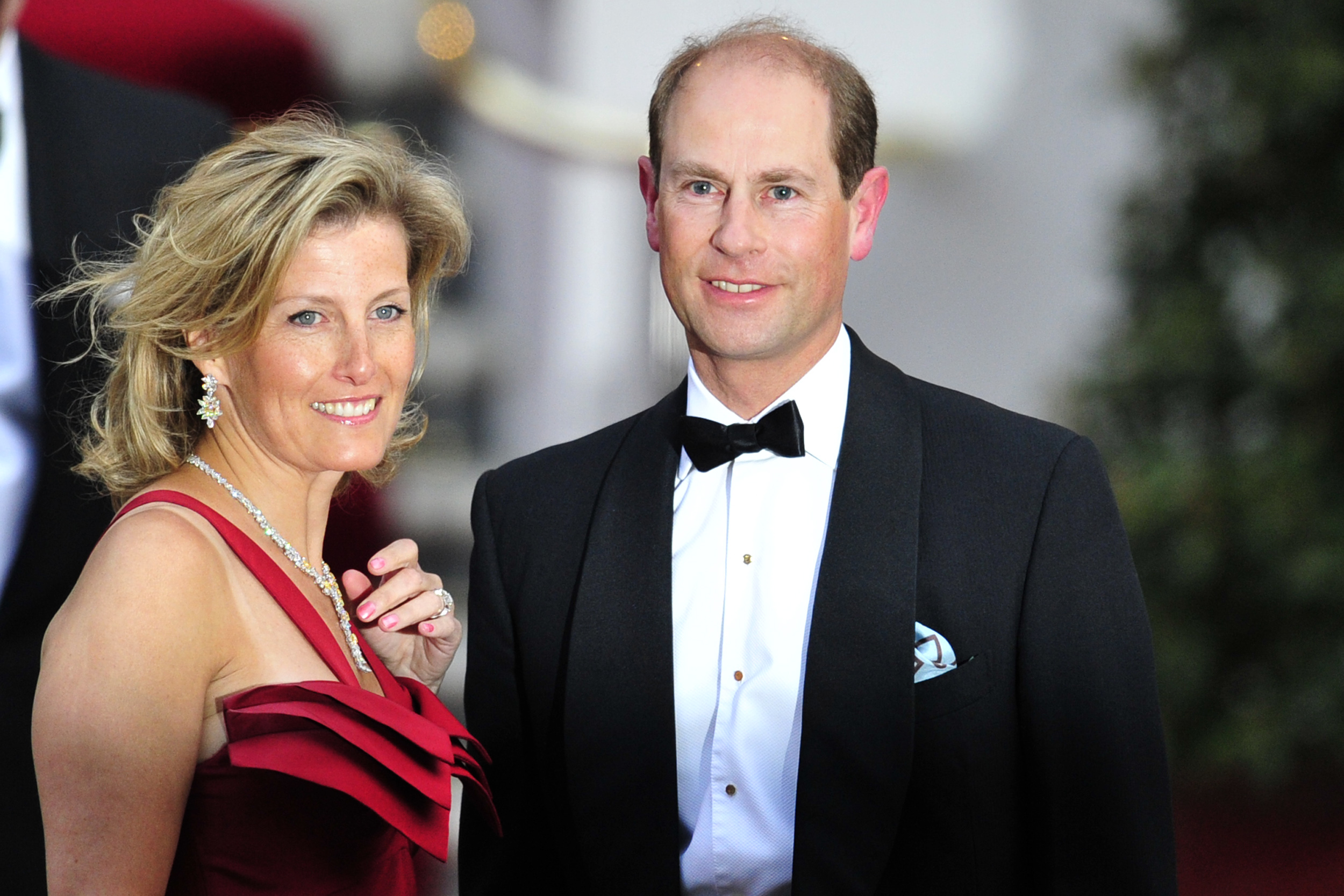 Prince Edward in a tuxedo and Sophie Wessex in a red gown at the Mandarin Oriental hotel for a gala dinner.