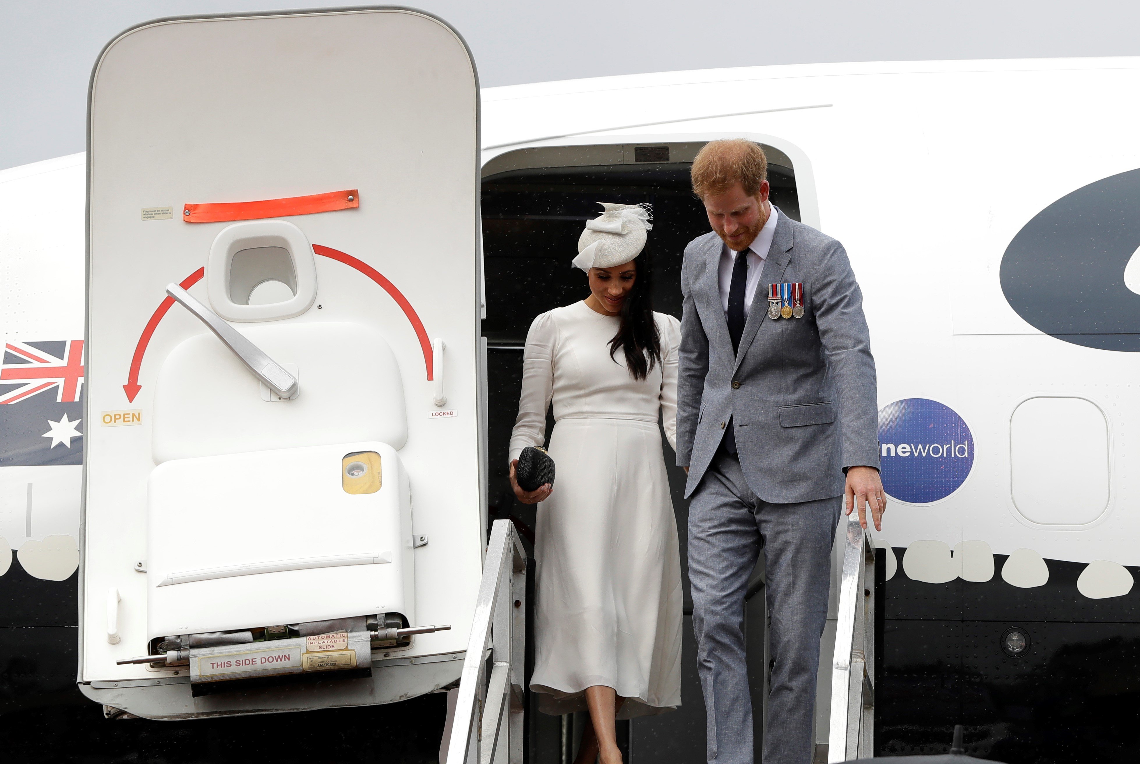 Prince Harry and Meghan disembark from plane upon arrival in Suva