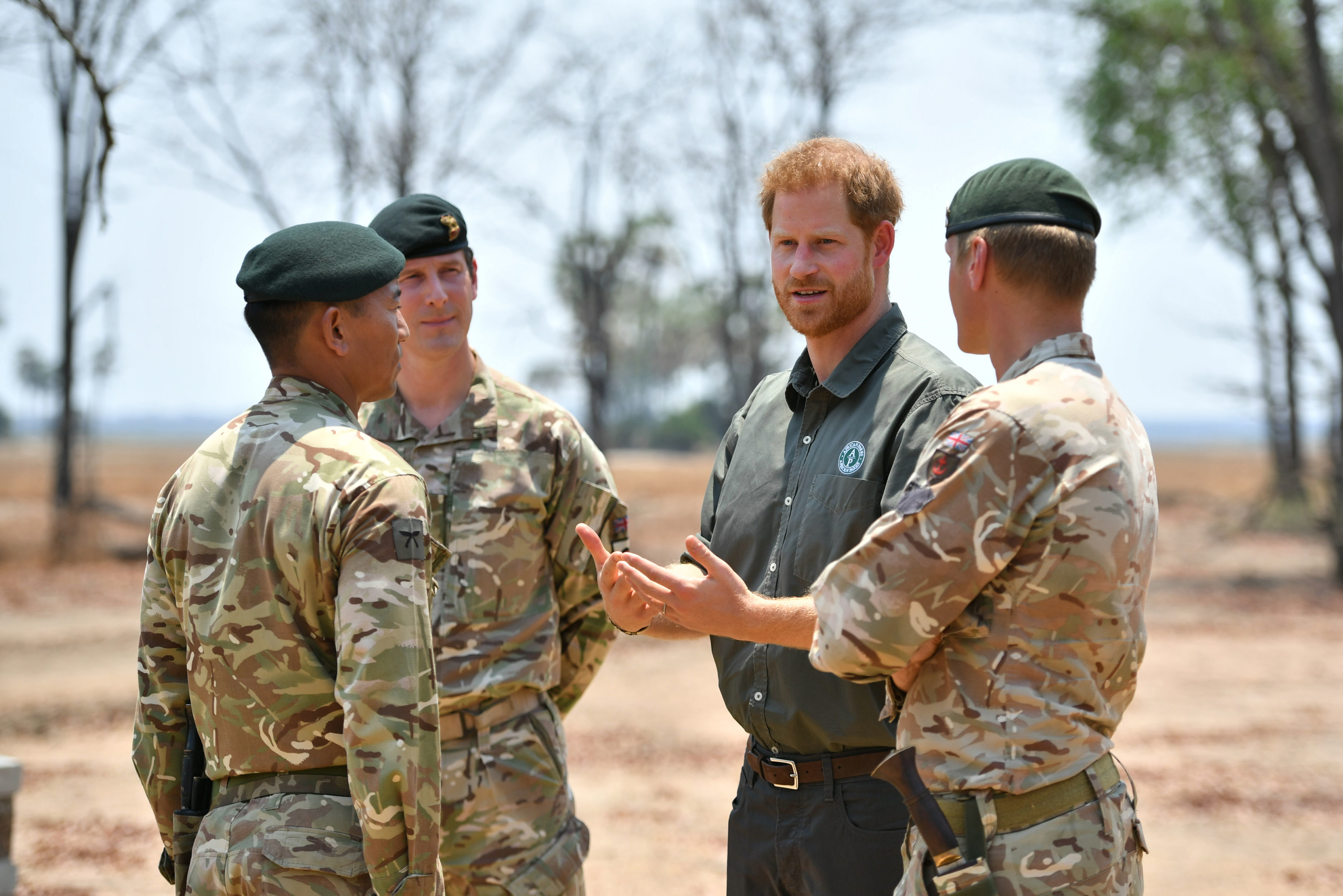 Prince speaks with servicemen as he pays tribute at the memorial site for Guardsman Mathew Talbot of the Coldstream Guards