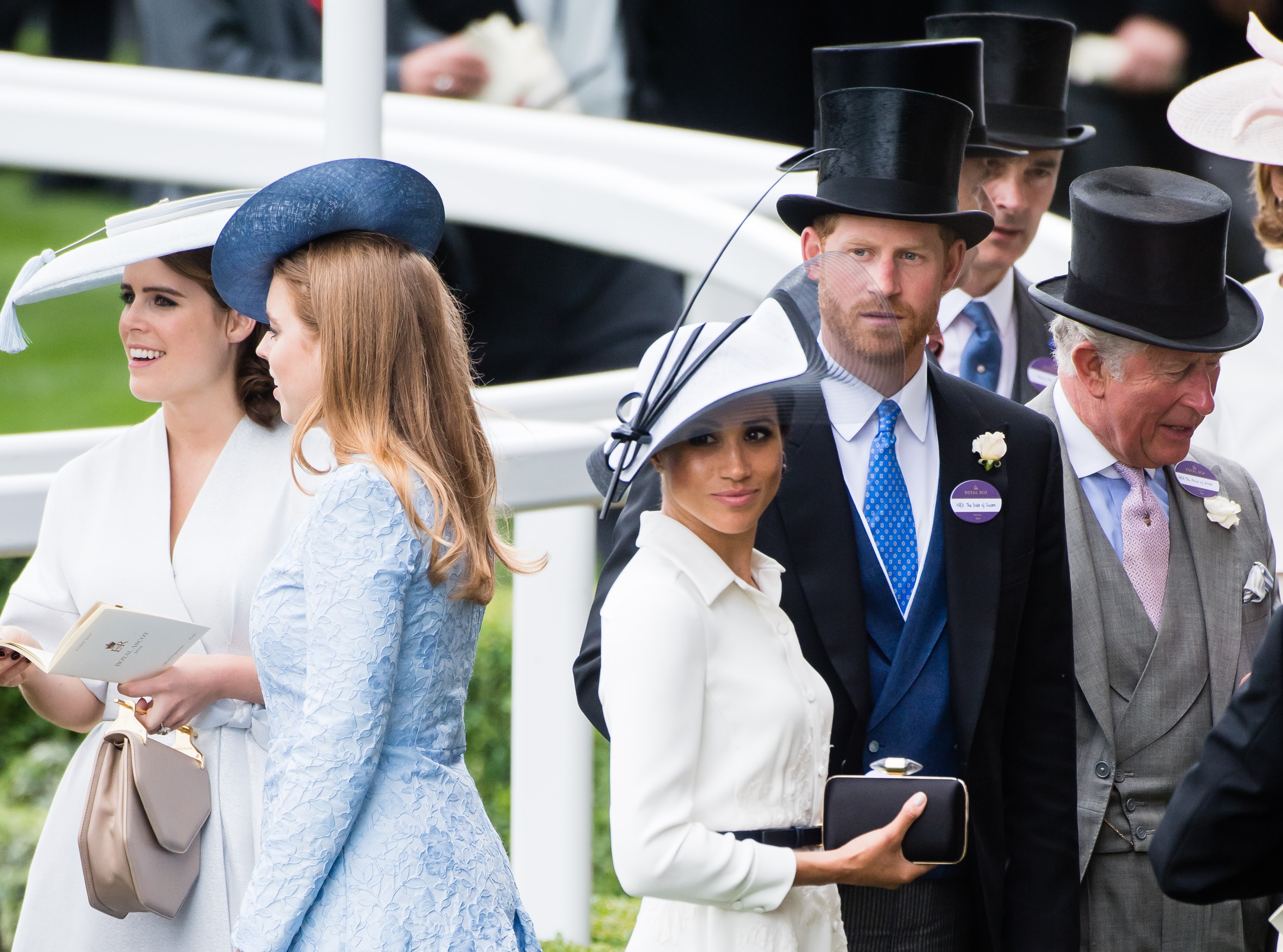 Princess Eugenie, Princess Beatrice, Meghan Markle, and Prince Harry standing by one another at the Royal Ascot