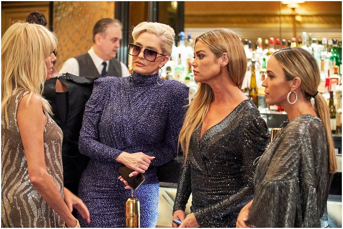 'RHOBH' cast members Teddi Mellencamp, Sutton Stracke, Erika Jayne, and Denise Richards looking at each other's eyes while filming a scene.