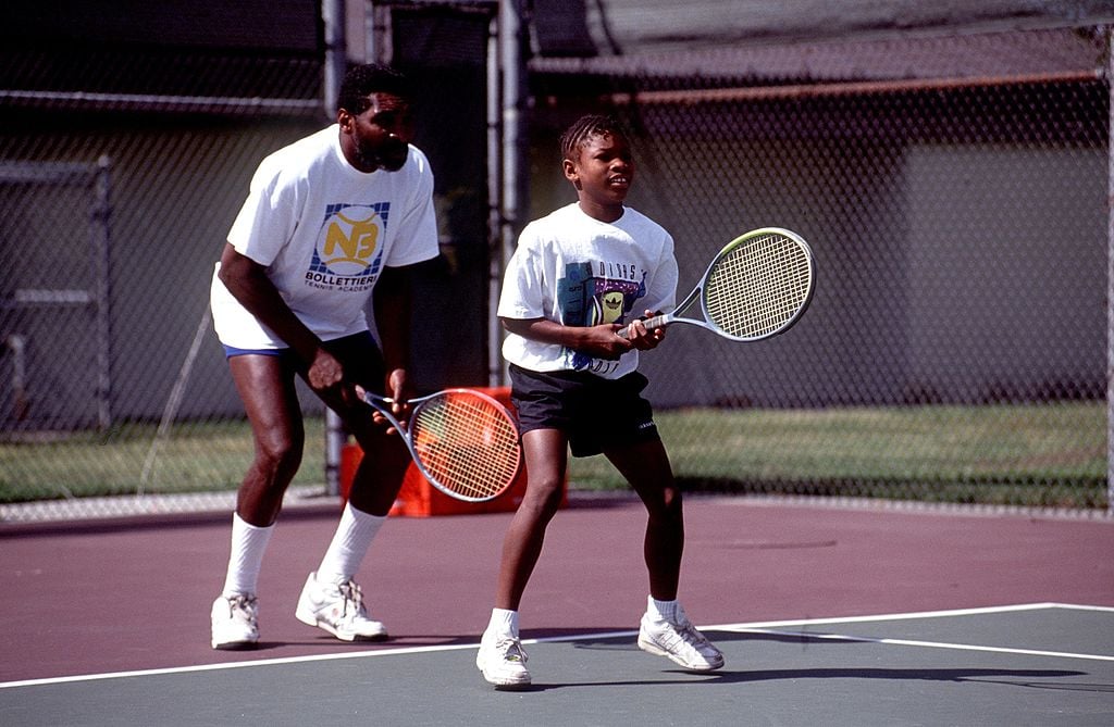 Richard Williams practices with his young daughter, Serena play tennis on the tennis court in 1991.