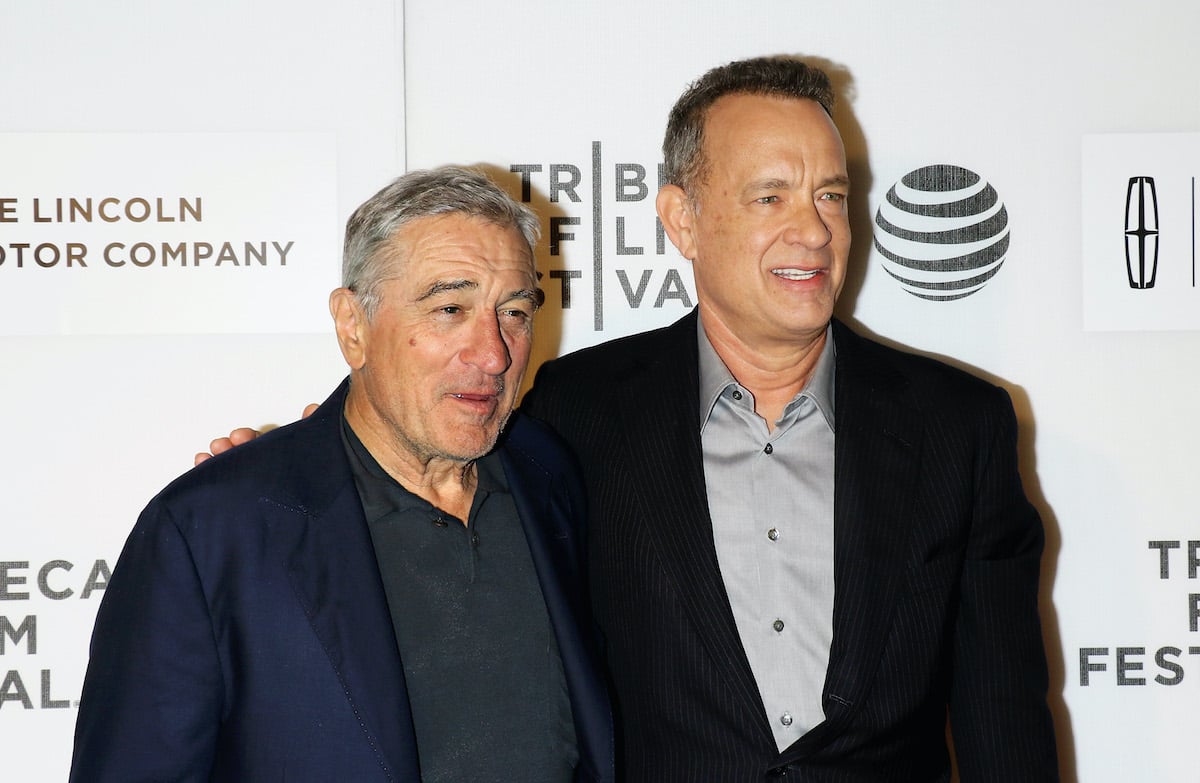 Robert De Niro and Tom Hanks smile and pose on the red carpet