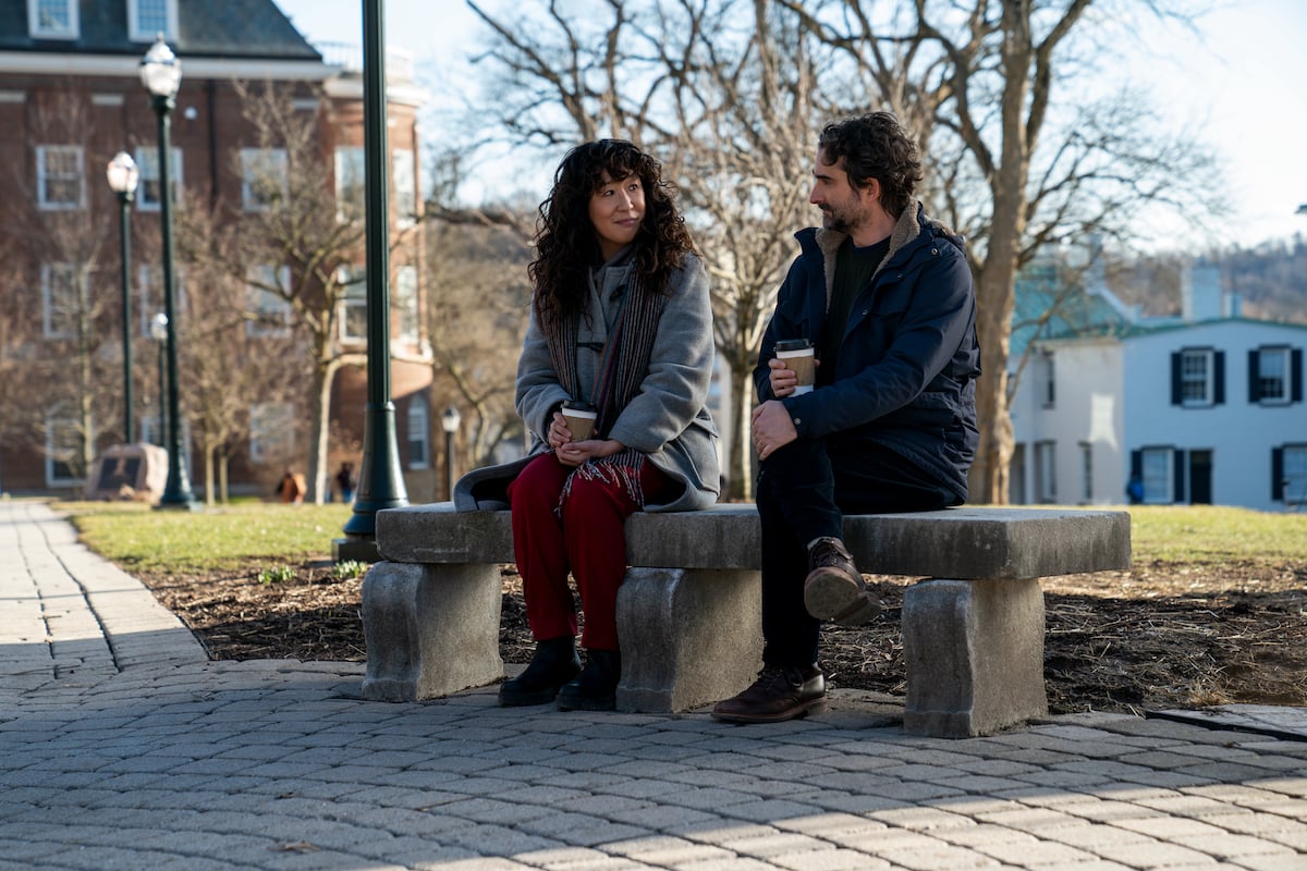 Sandra Oh and Jay Duplass sit at a bench holding cups of coffee in 'The Chair' Season 1 Episode 6