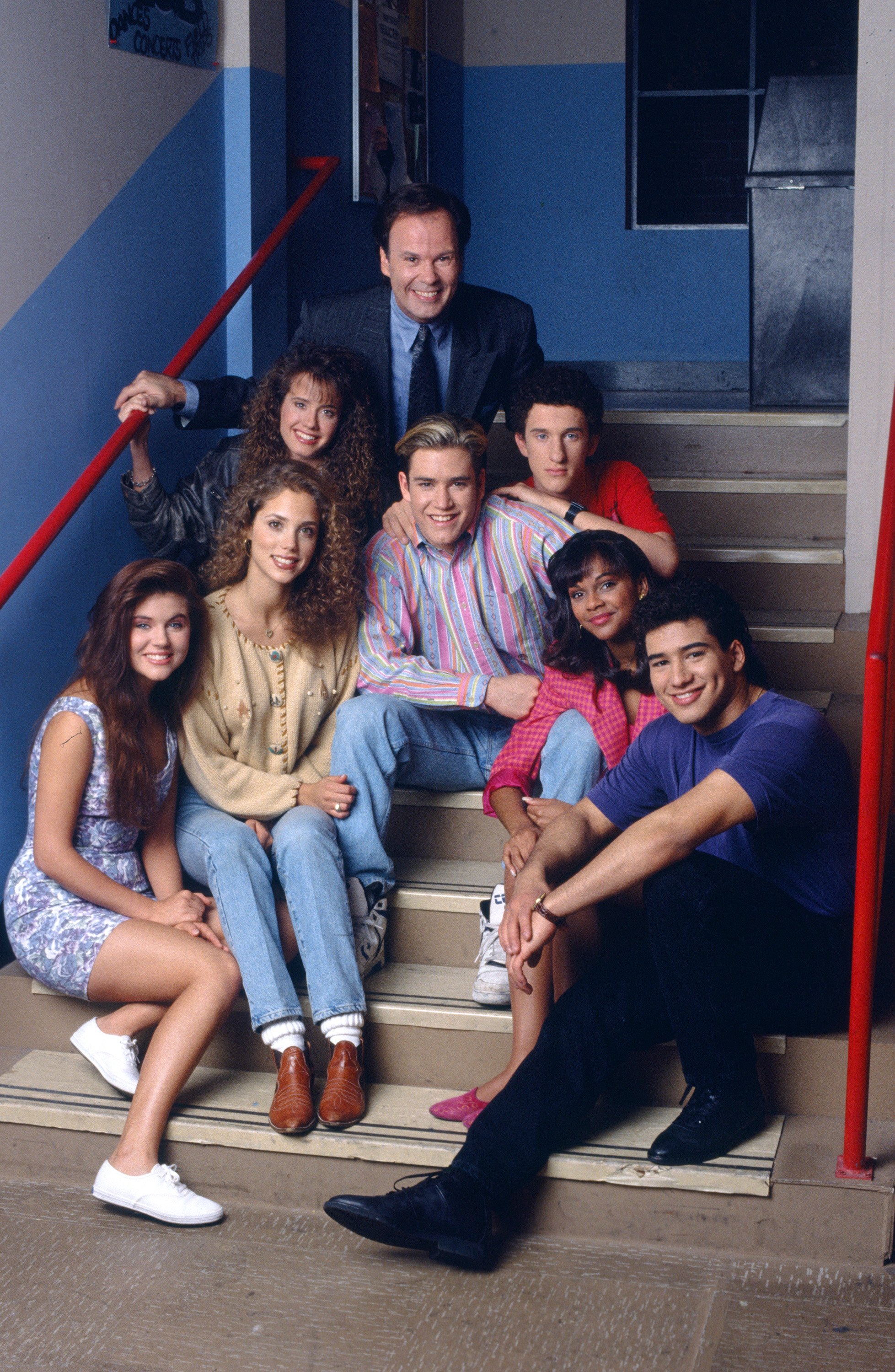 Tiffani Thiessen, Elizabeth Berkley, Leanna Creel, Dennis Haskins, Mark-Paul Gosselaar, Dustin Diamond, Lark Voorhies and Mario Lopez pose on the steps of Bayside High