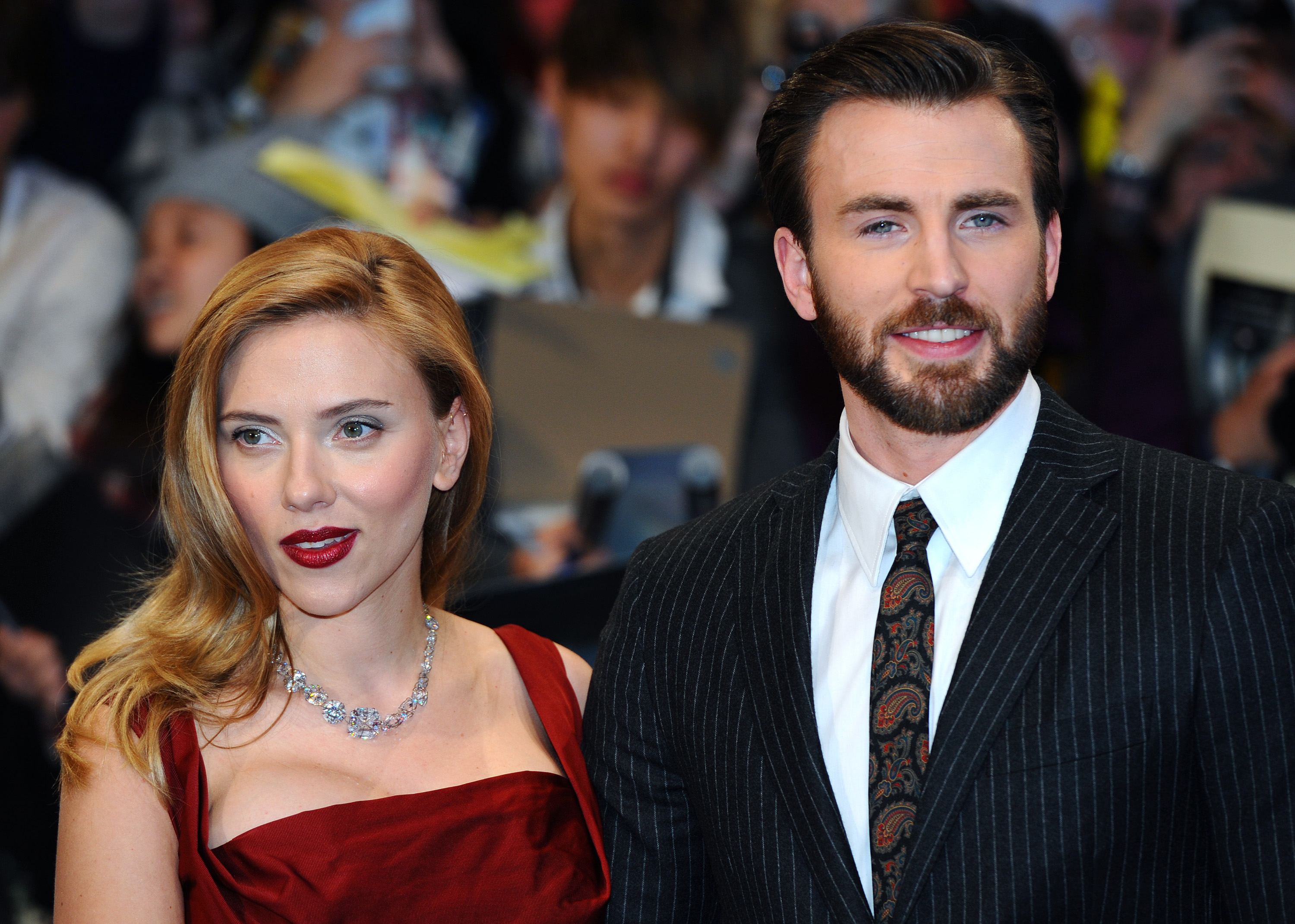 Scarlett Johansson and Chris Evans 'Ghosted' wearing red dress and suit and tie at premiere