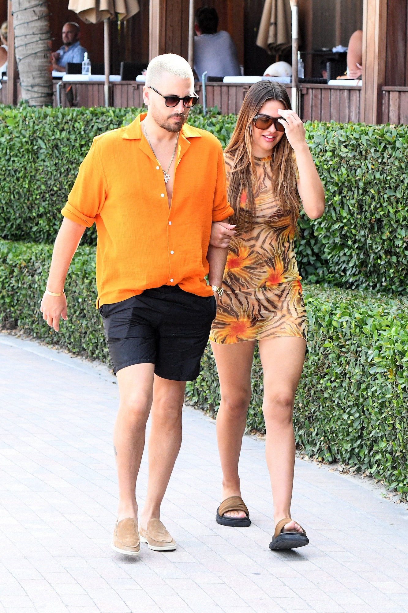 Scott Disick and Amelia Hamlin holding hands while walking on the beach in Miami