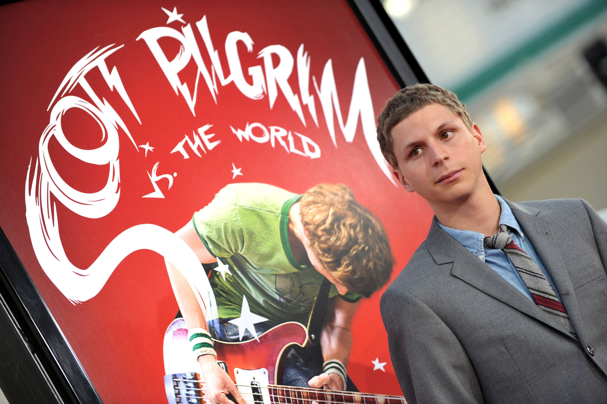 Michael Cera at the 'Scott Pilgrim vs. the World' premiere in front of a movie poster
