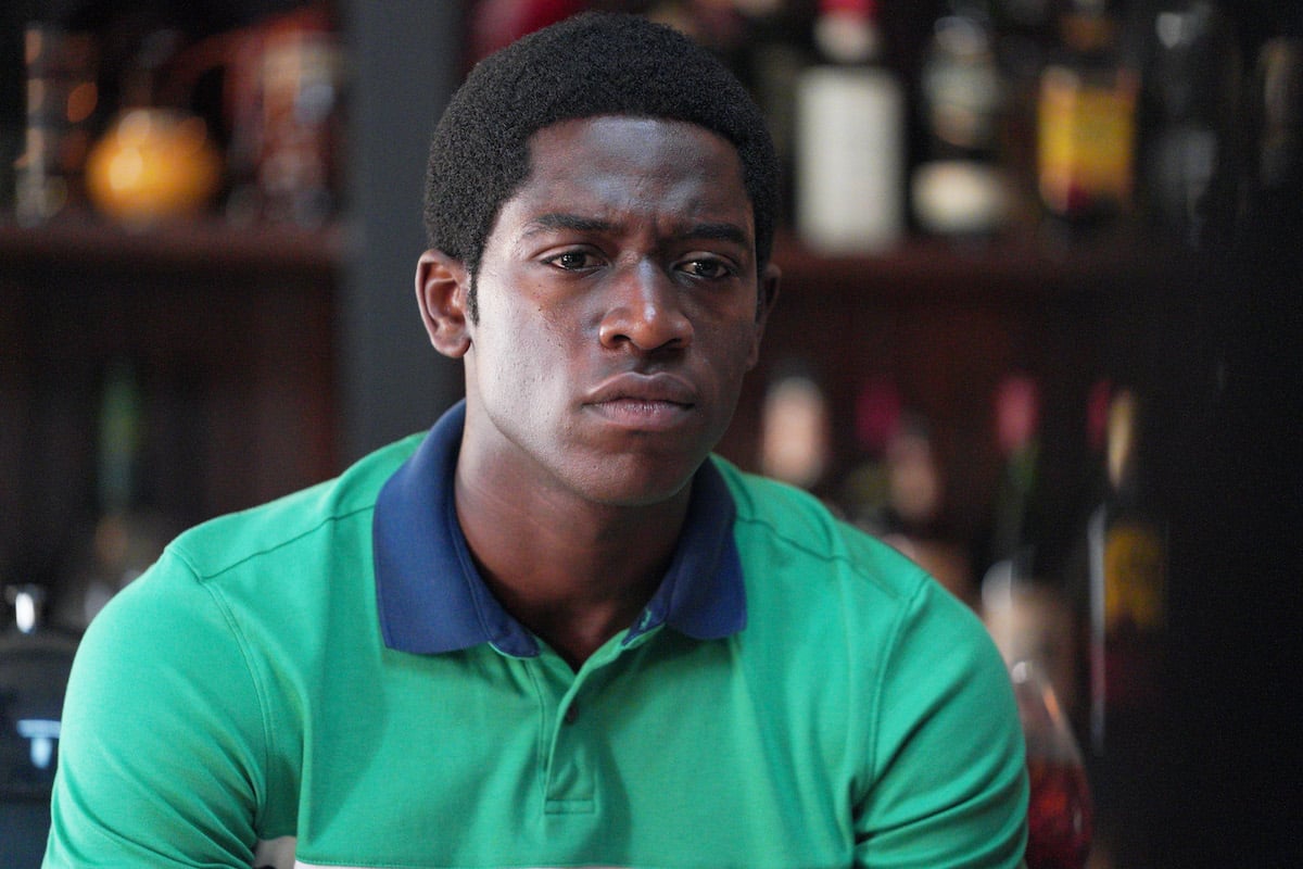 Damson Idris wears a green shirt while filming for his show 'Snowfall'