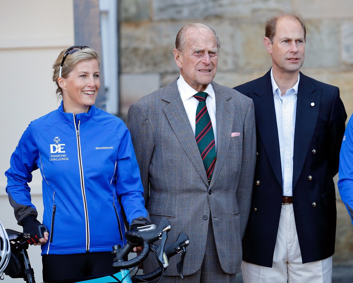 Sophie, Countess of Wessex posing for a photograph alongside Prince Philip and Prince Edward