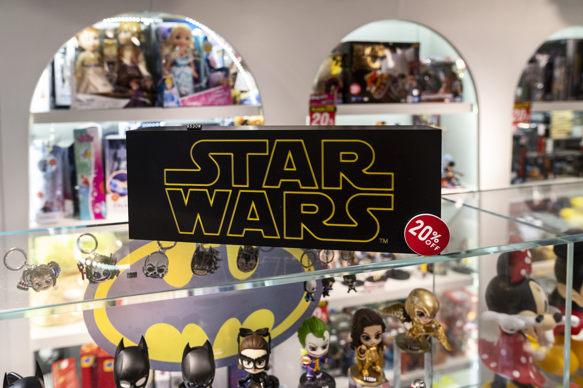 Star Wars logo on a glass case with Star Wars figurines