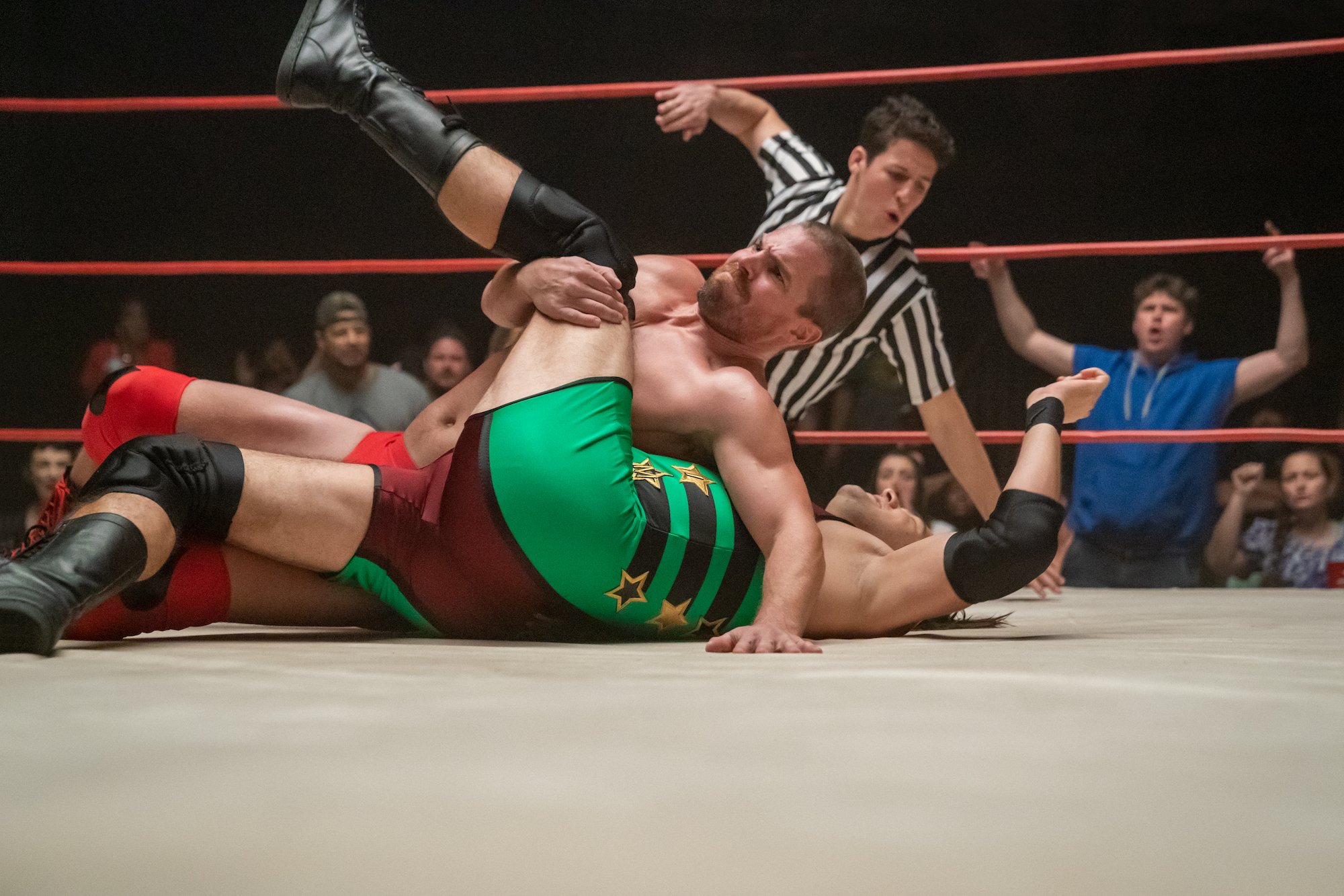 Stephen Amell pins his opponent in Heels