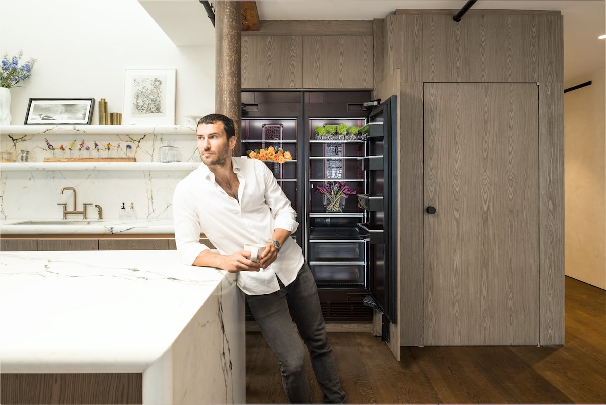 Steve Gold from 'Million Dollar Listing New York' leaning against a kitchen island