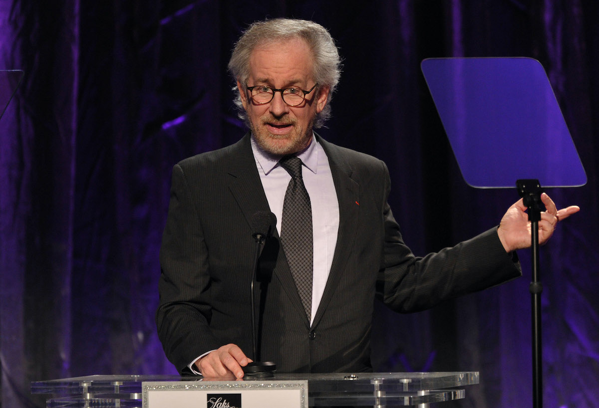 Steven Spielberg wears a suit and speaks at a podium on stage