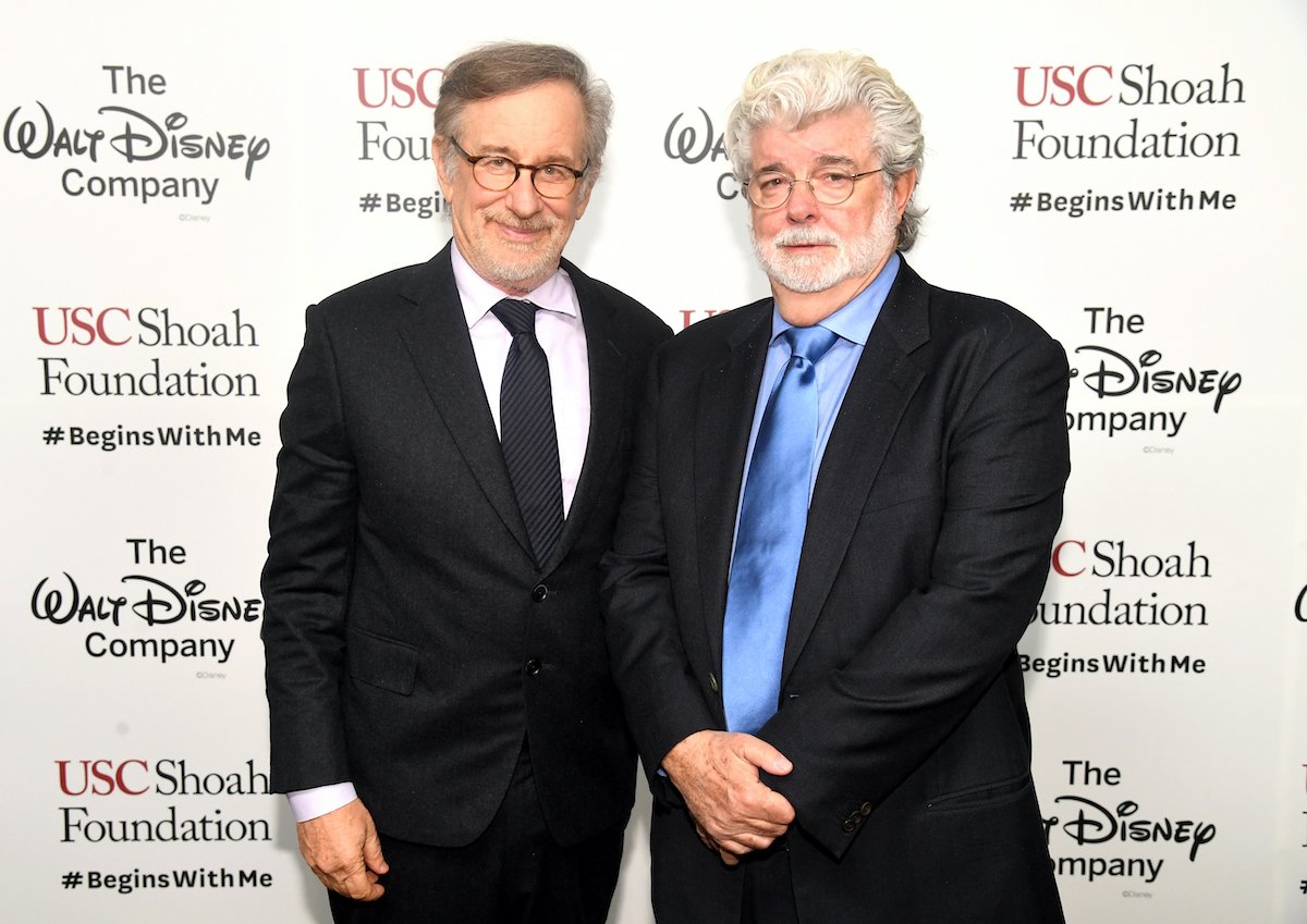 Steven Spielberg and George Lucas wear suits and pose on the red carpet