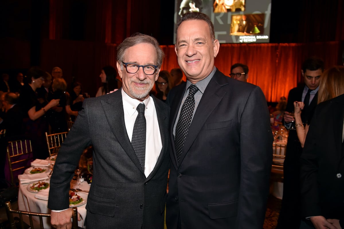 Steven Spielberg and Tom Hanks wear suits and pose