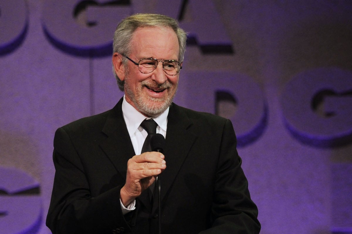 Steven Spielberg holds a mic while speaking onstage
