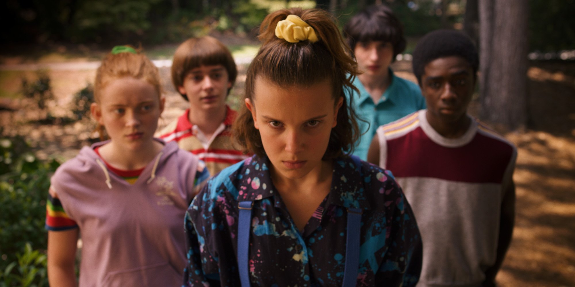 Stranger Things stars Sadie Sink, Noah Schnapp, Millie Bobby Brown, Finn Wolfhard, and Caleb McLaughlin staring at the camera