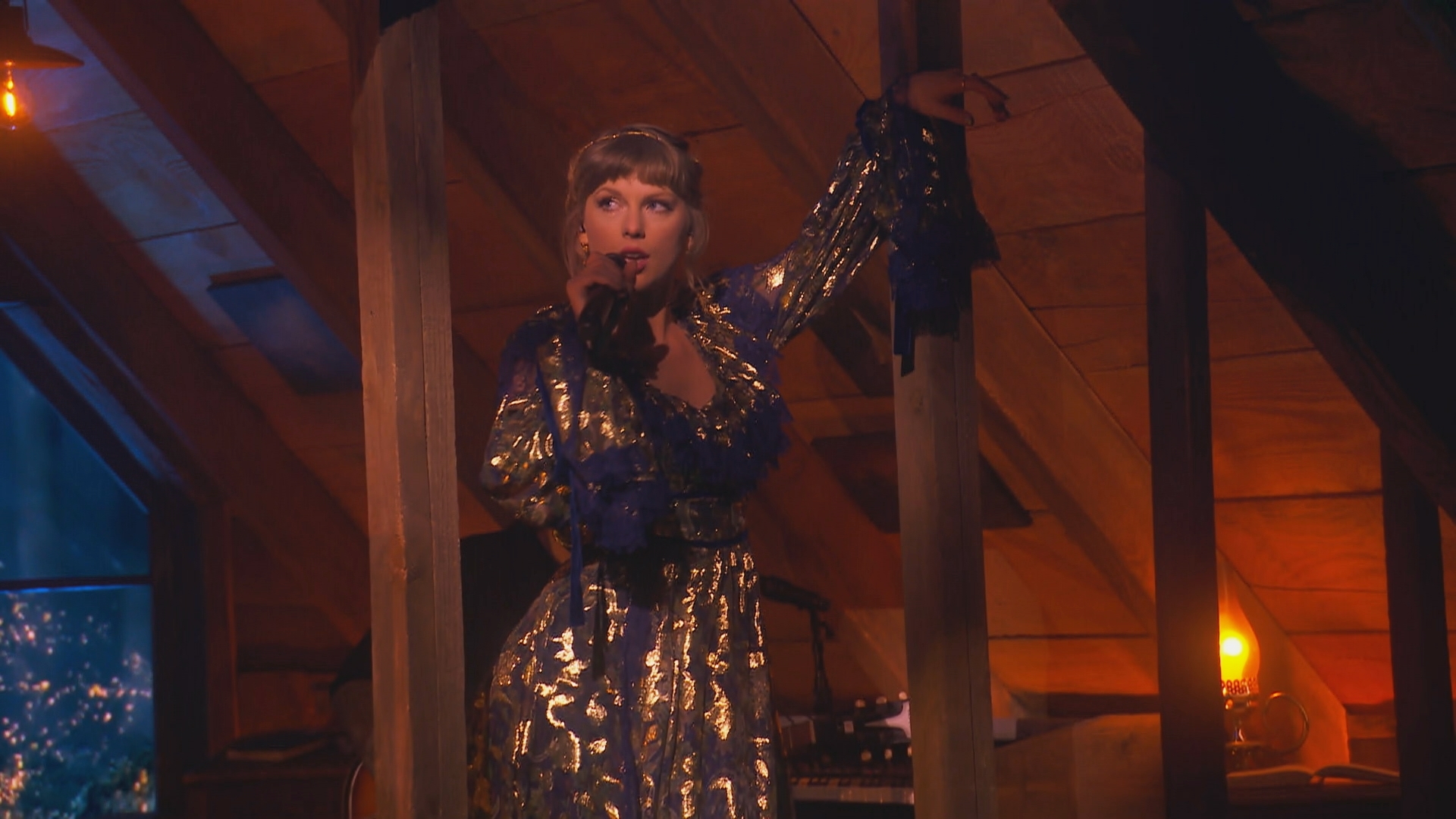 Taylor Swift leans against a wooden beam while performing at the 2021 Grammy Awards