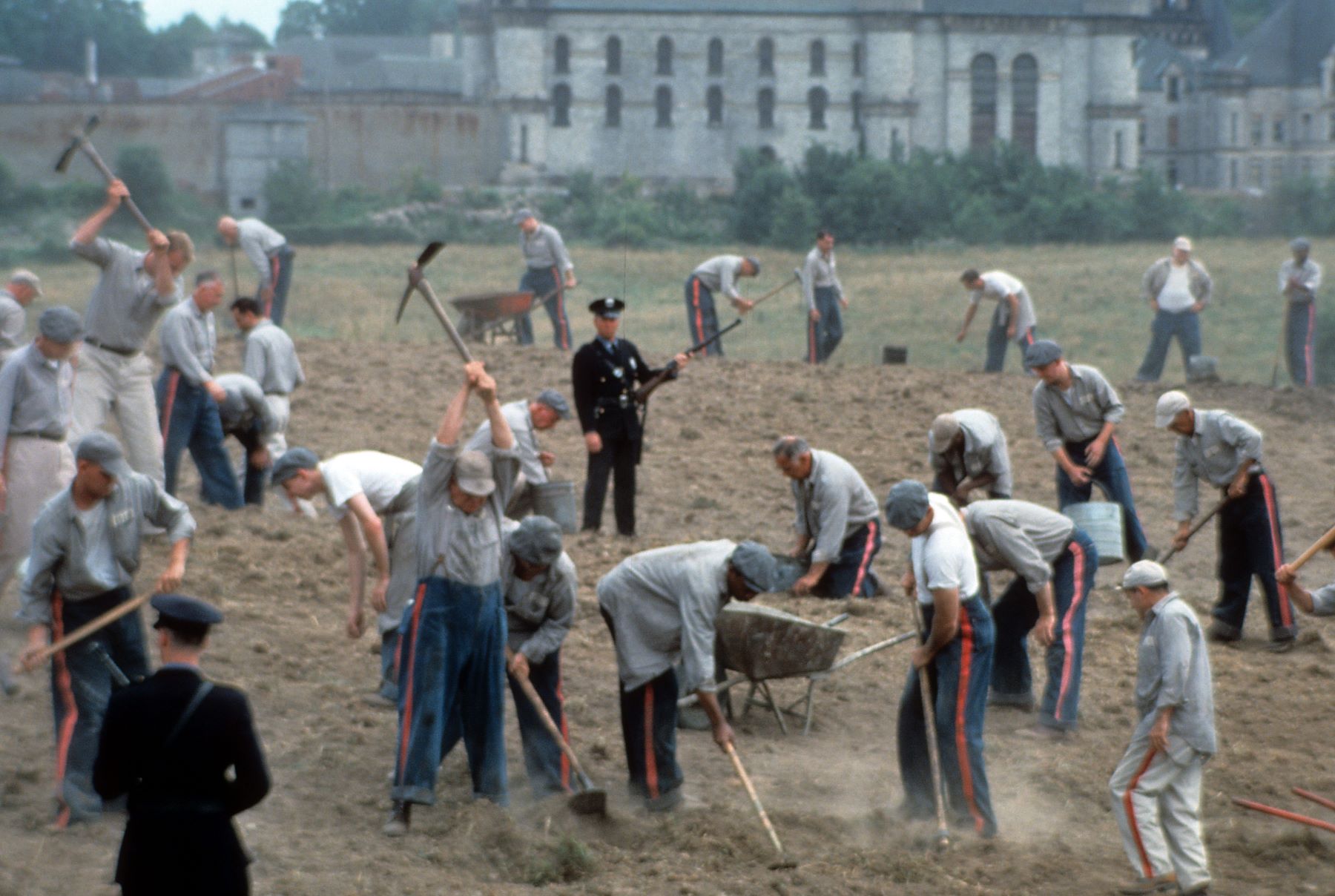 Prisoners working and digging in a field outside of the prison in 'The Shawshank Redemption'