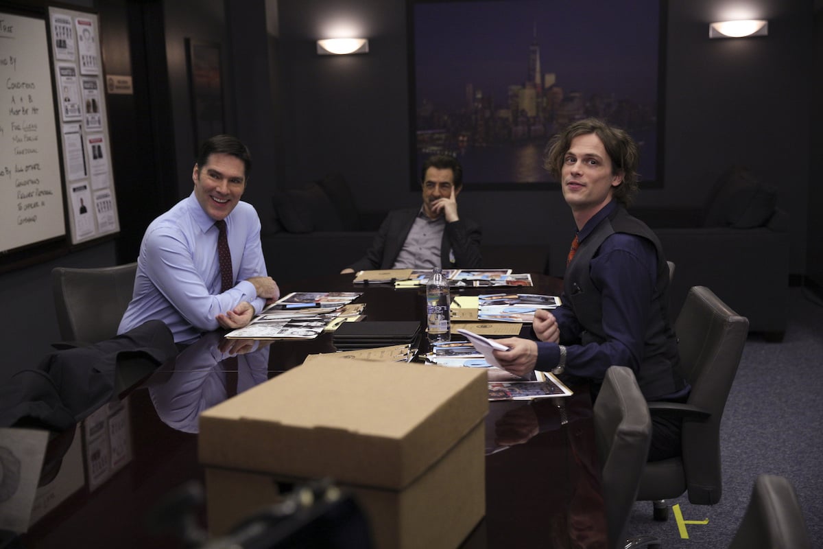 Thomas Gibson as Aaron Hotchner, Joe Mantegna as David Rossi, and Matthew Gray Gubler as Dr. Spencer Reid sitting together in 'Criminal Minds'