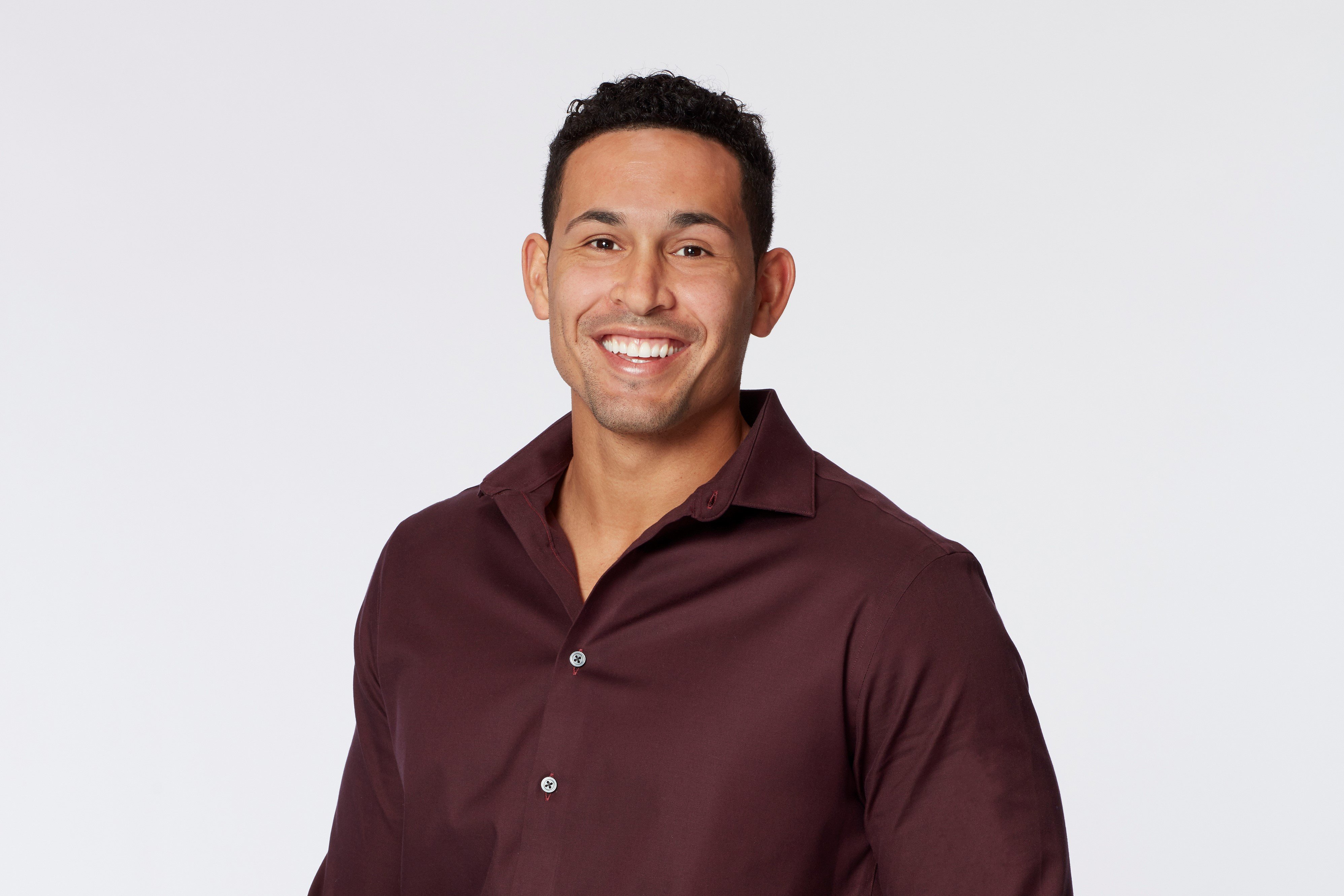 Thomas Jacobs in a maroon shirt.