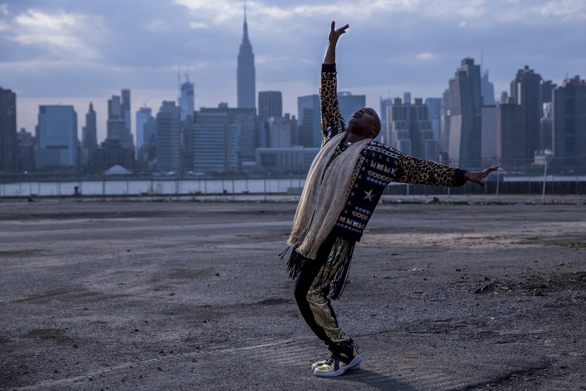 'Unbreakable Kimmy Schmidt' episode titled 'Kimmy Fights a Fire Monster!' titus posing in front of the New York City skyline