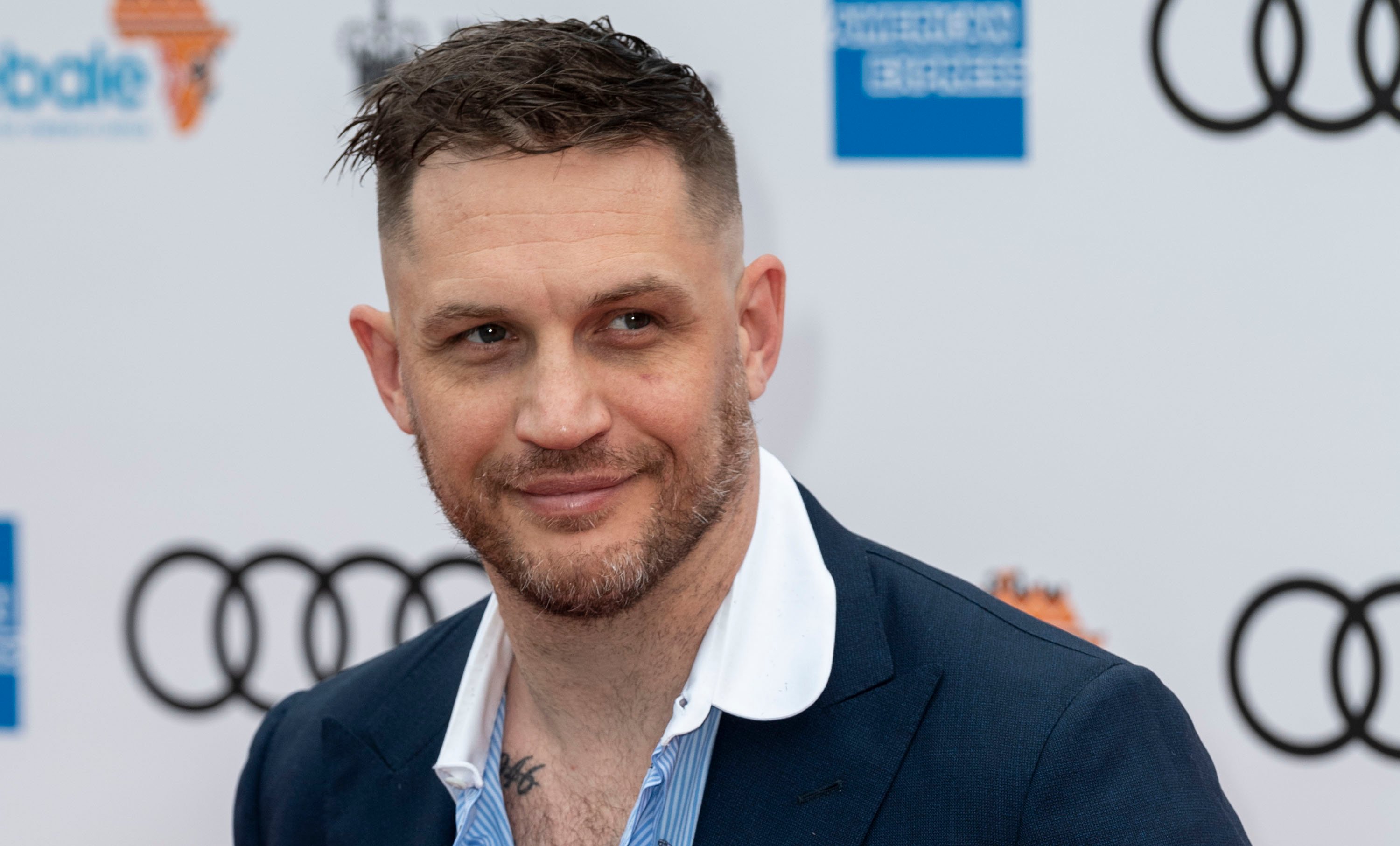 Tom Hardy smiles for a photo at the Sentebale Audi Concert at Hampton Court Palace