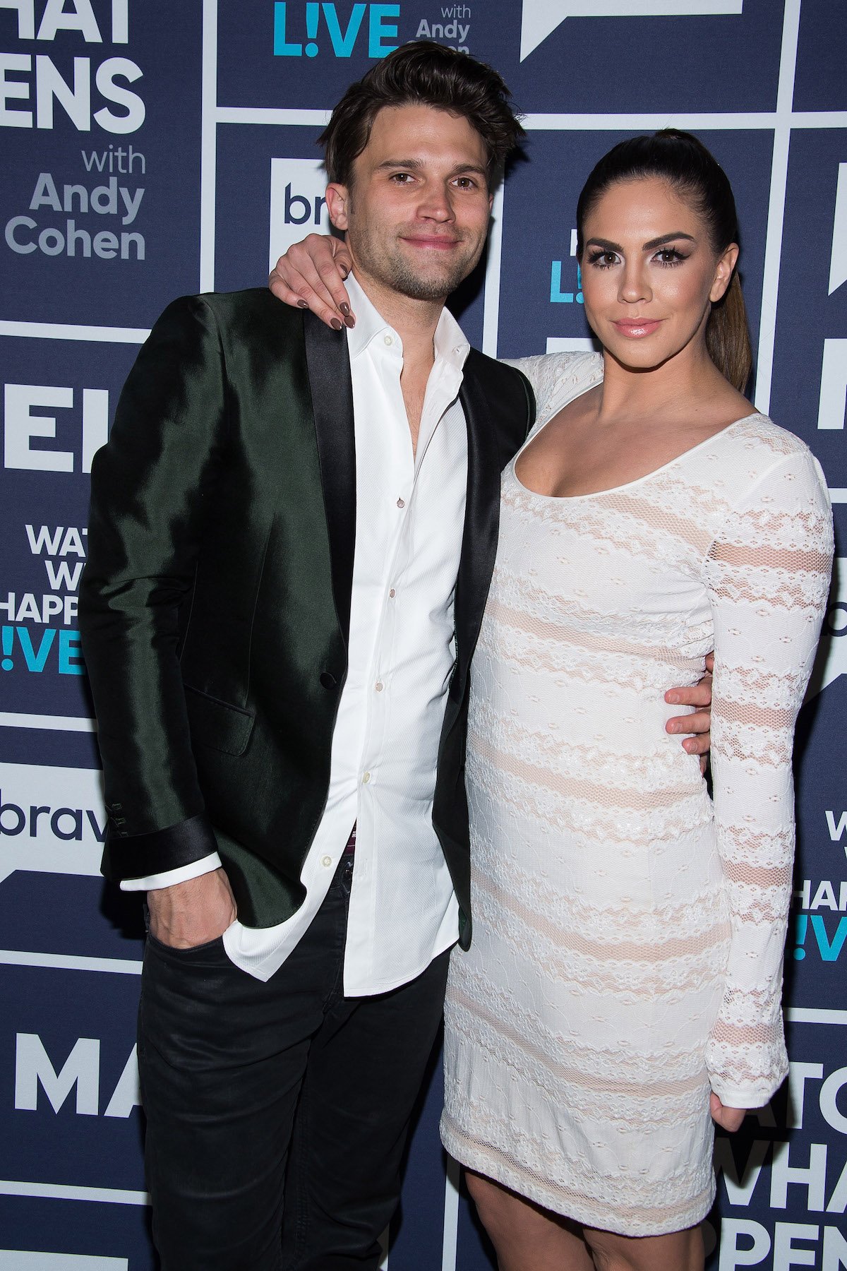 Tom Schwartz and Katie Maloney smile and pose for the camera at an event.