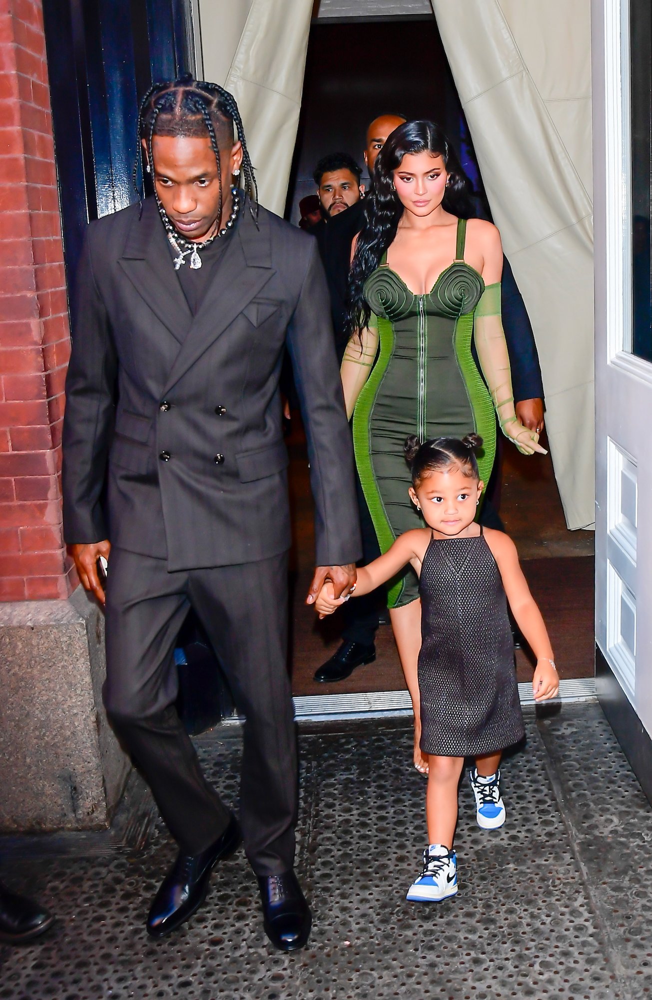 Travis Scott, Kylie Jenner, and their daughter Stormi Webster walking in New York City in June 2021
