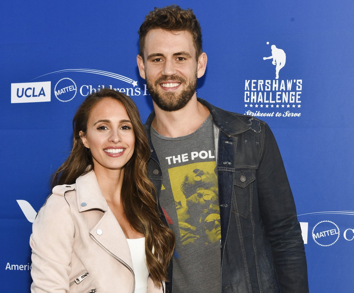 Vanessa Grimaldi and Nick Viall dressed casually at an event, facing the camera and smiling with their arms around each other.