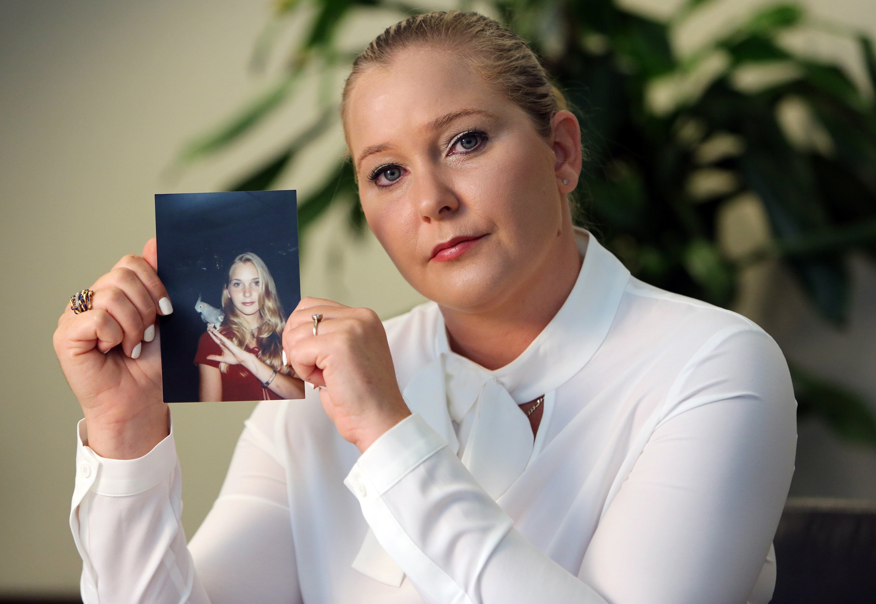 Virginia Roberts holds a photo of herself at age 16, when Jeffrey Epstein allegedly began abusing her