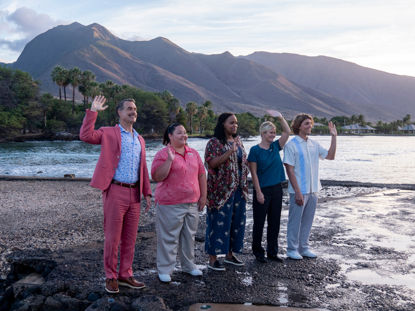 Murray Bartlett, Jolene Purdy, Natasha Rothwell, and Lukas Gage in 'The White Lotus' premiere, which is paralleled in the finale. They're standing on the beach and waving.