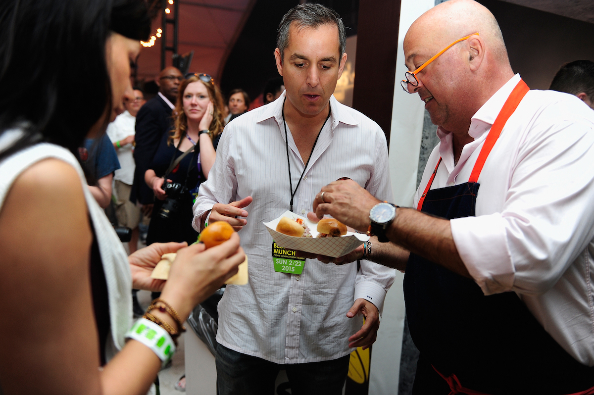 Andrew Zimmern eating with friends
