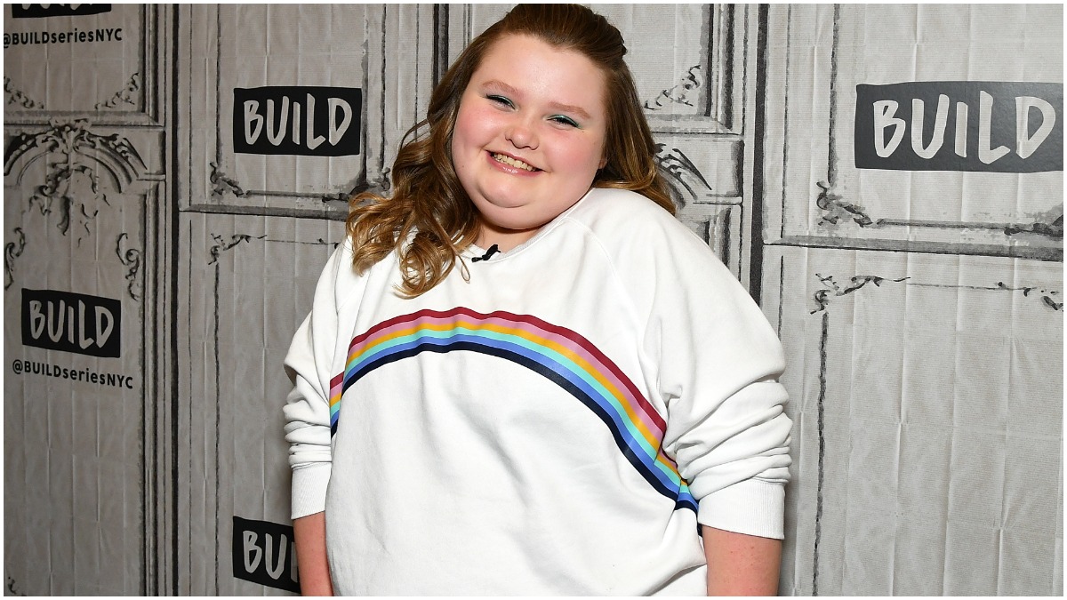 Alana Thompson poses in a rainbow shirt for a press event.