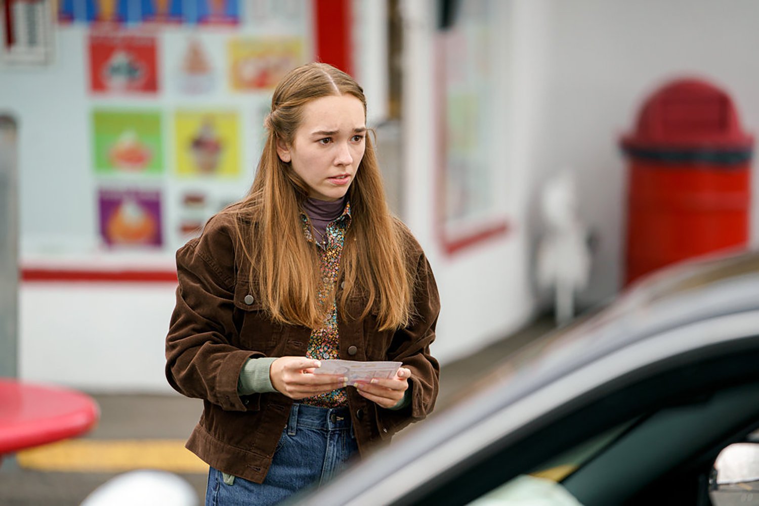 Holly Taylor stands beside a car as Angelina in Manifest