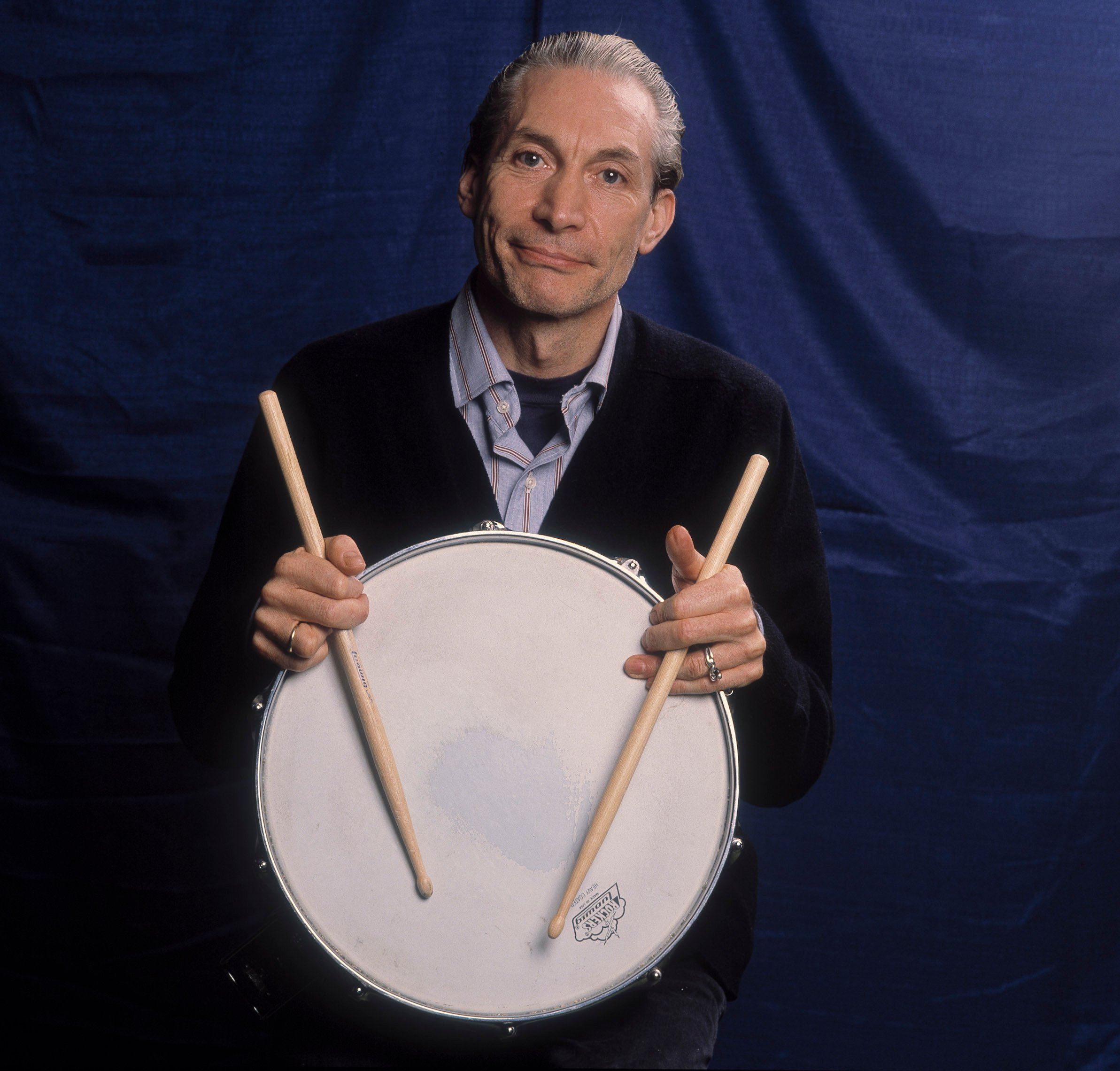 The Rolling Stones' Charlie Watts with a drum