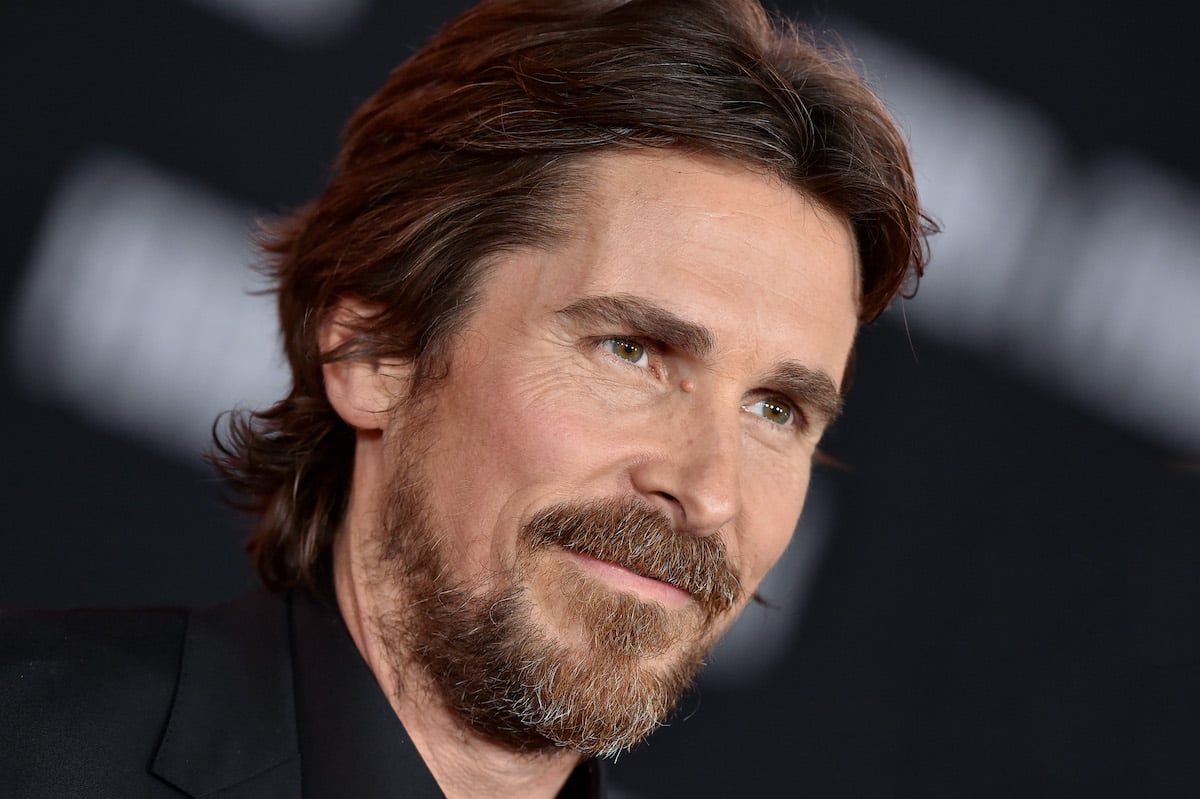 Christian Bale wears black and smiles on the red carpet