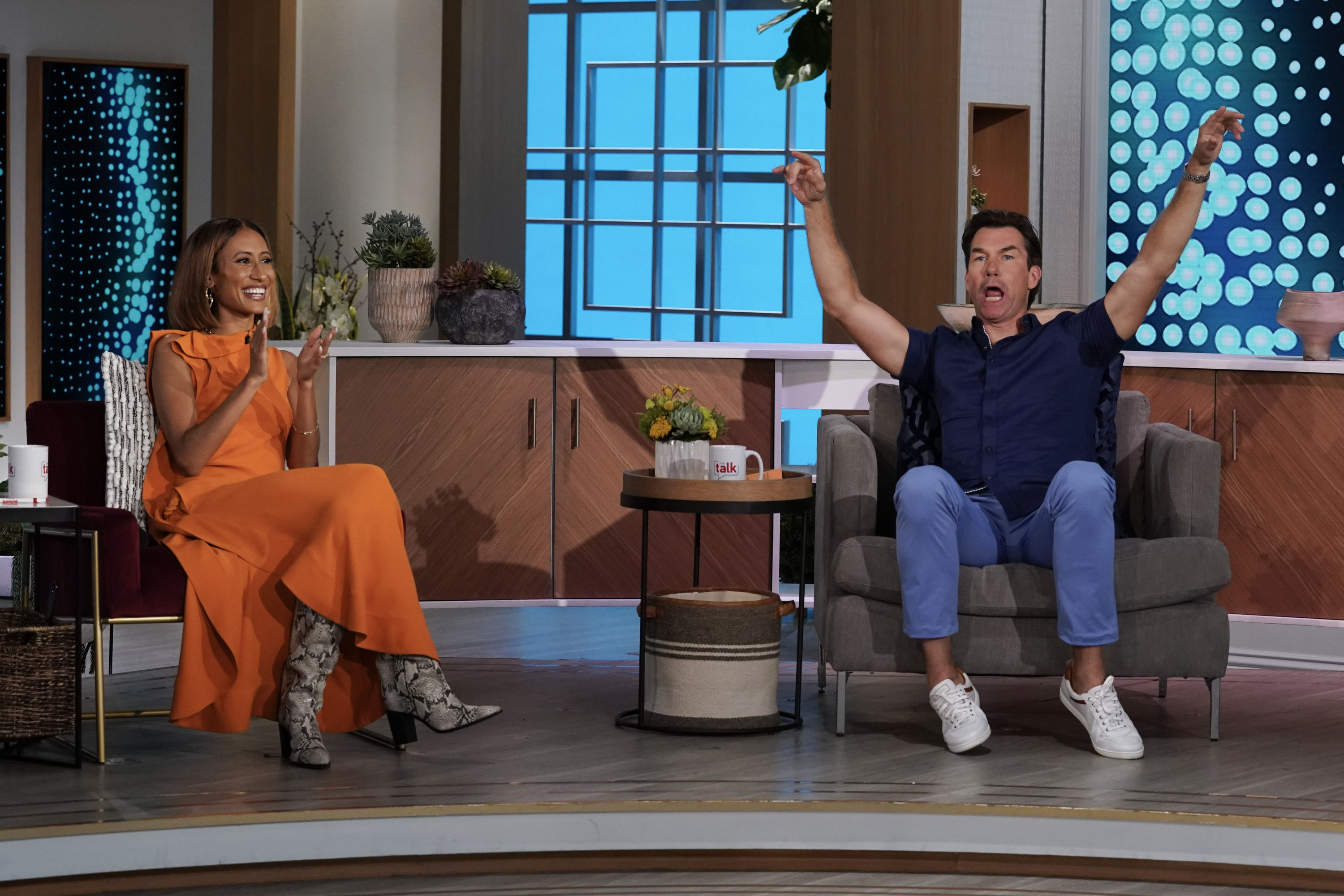 Elaine Welteroth claps while Jerry O'Connell cheers on the set of 'The Talk'