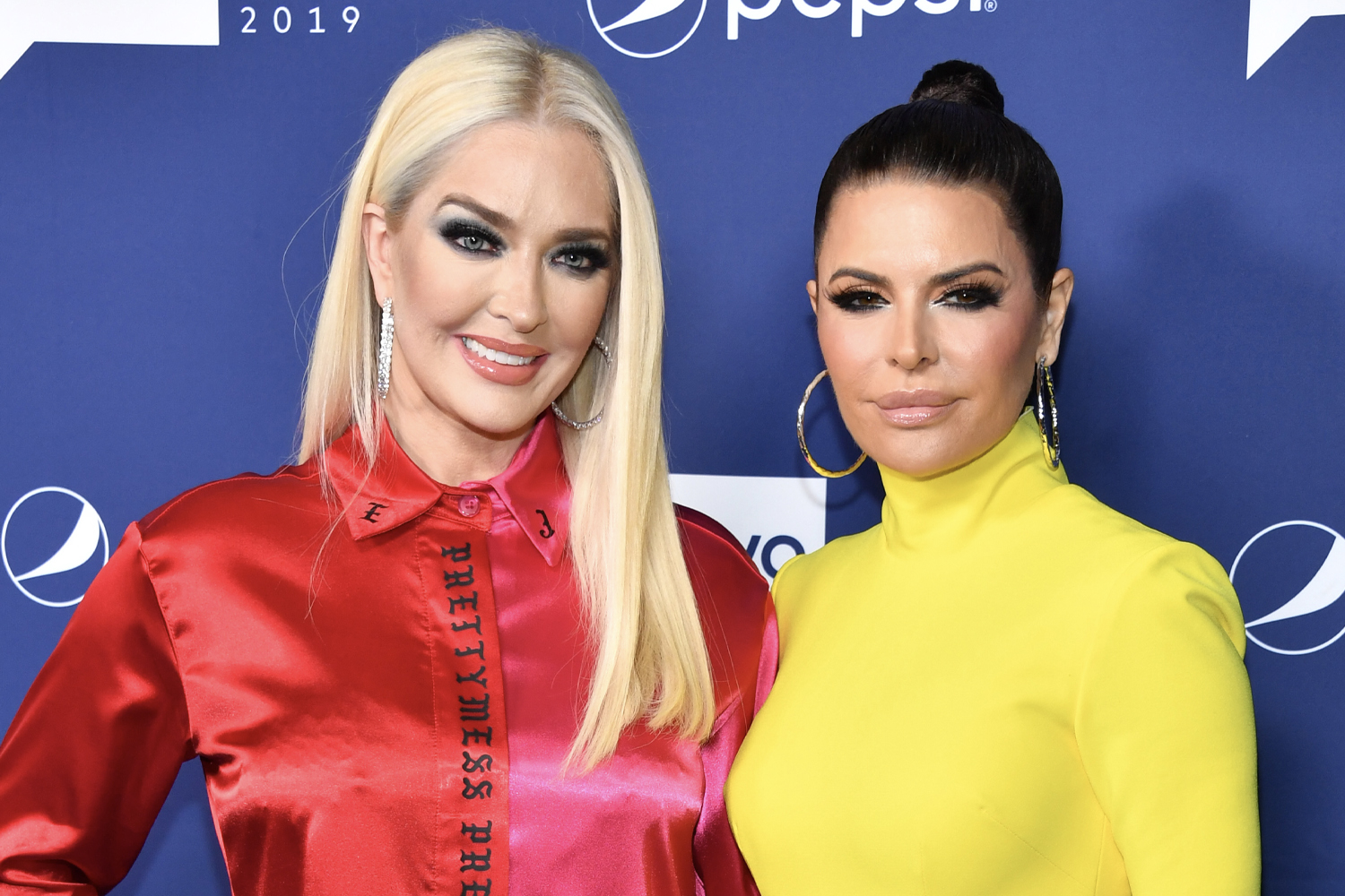 Erika Jayne and Lisa Rinna smiling during an appearance at BravoCon 2019