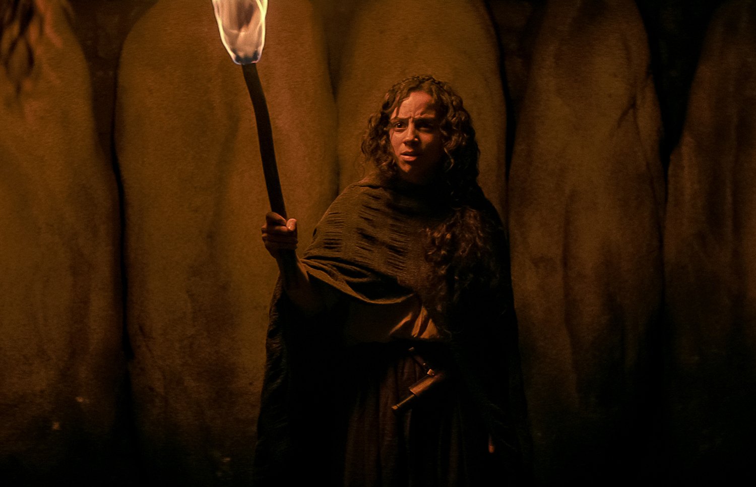 Kiana Madeira holds a lit torch in her hand as Sarah Fier in 'Fear Street Part 3: 1666'