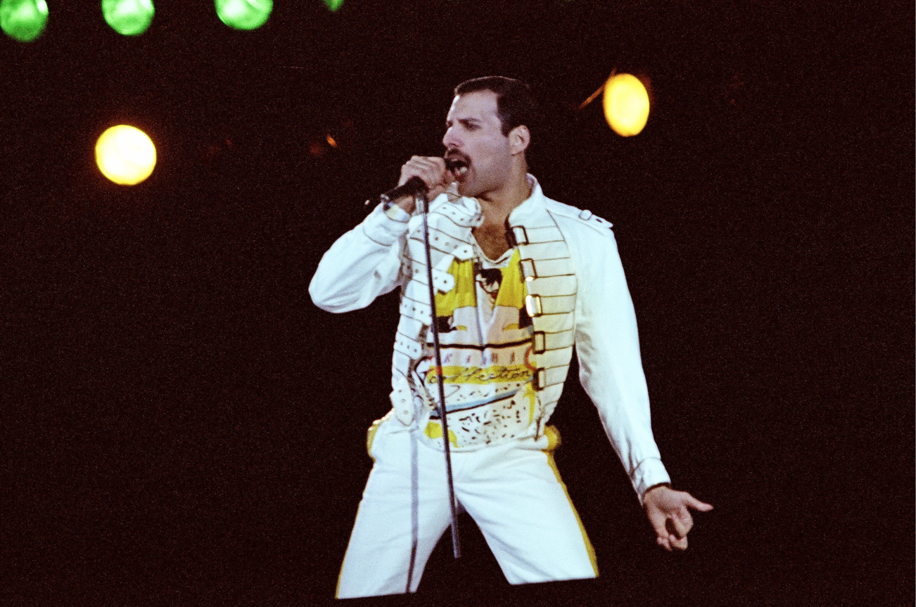Freddie Mercury wearing yellow and white