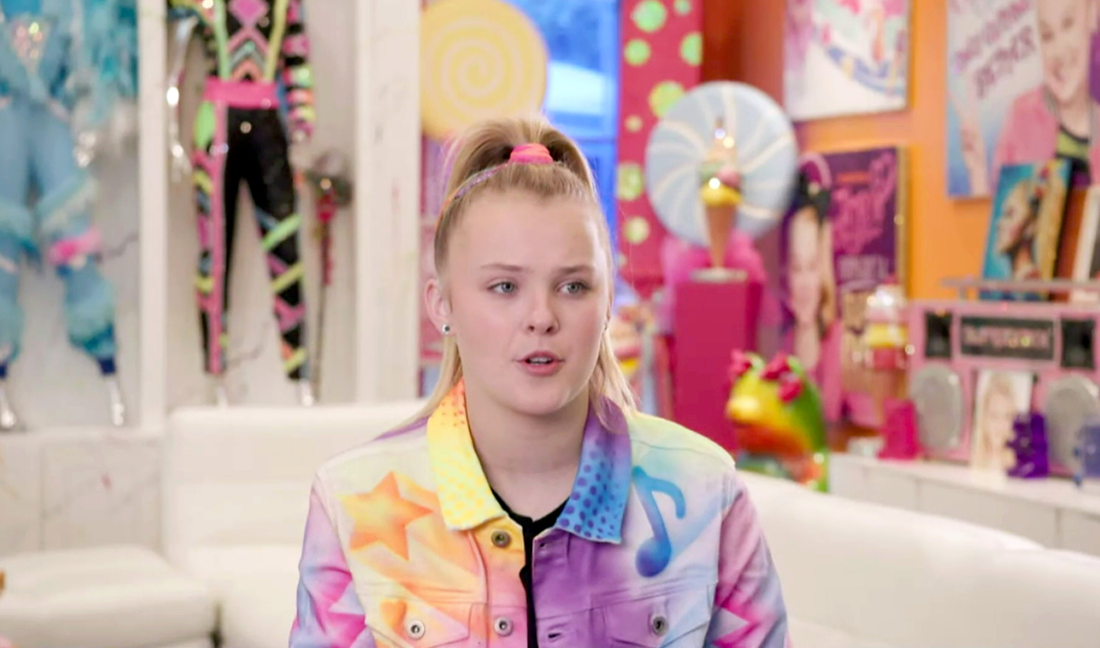 Jojo Siwa in a colorful jacket